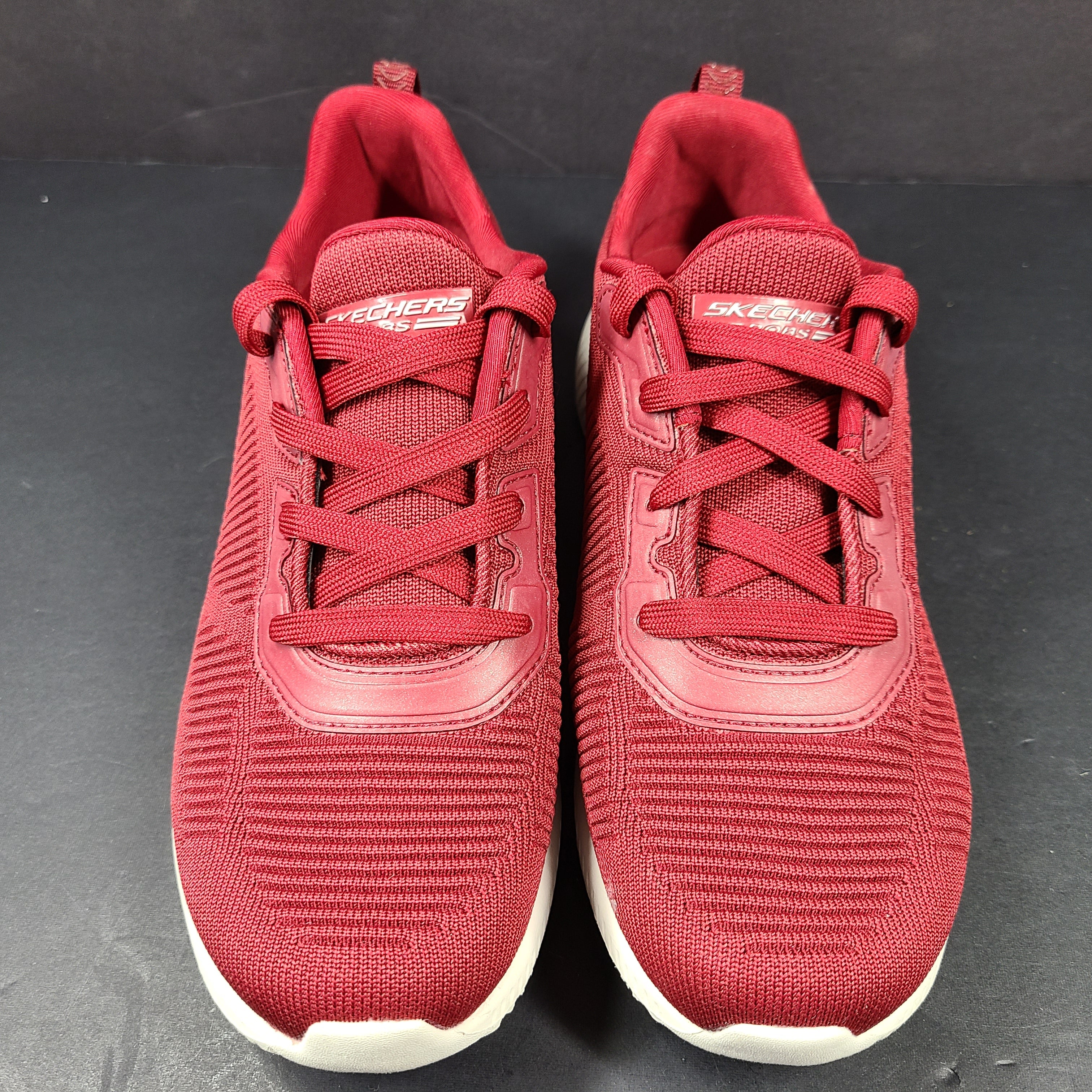 Red Skechers BOBS women's sneaker with cushioned memory foam insole and knit upper for everyday comfort.