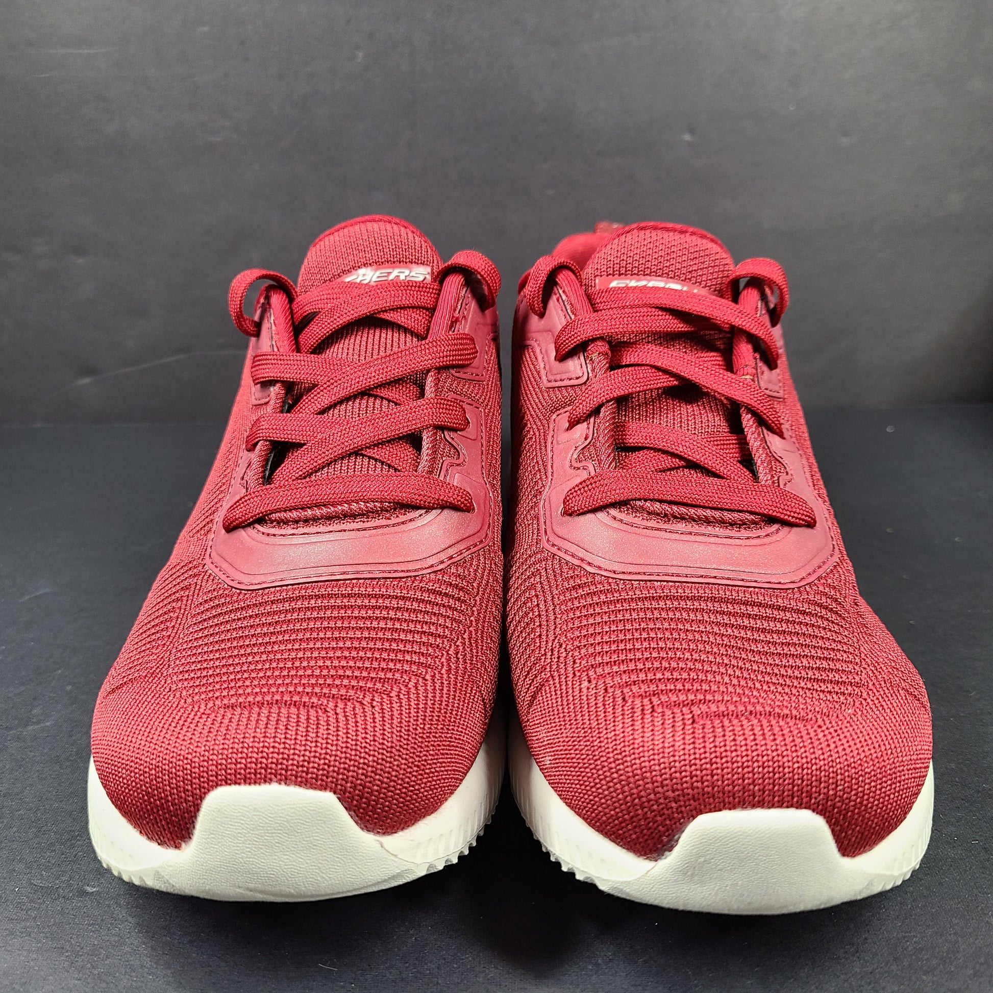 Red Skechers BOBS women's sneaker with cushioned memory foam insole and knit upper for everyday comfort.