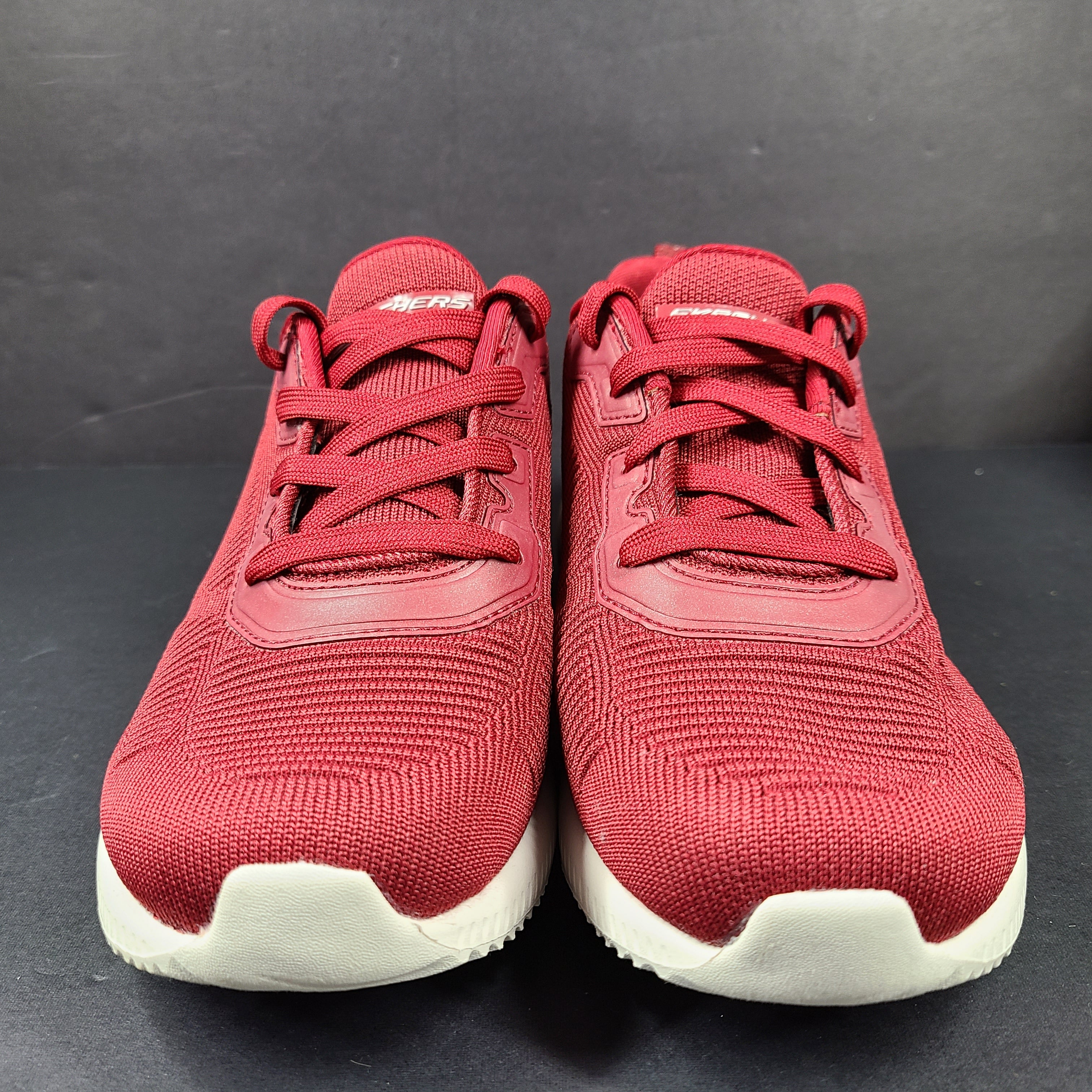 Red Skechers BOBS women's sneaker with cushioned memory foam insole and knit upper for everyday comfort.
