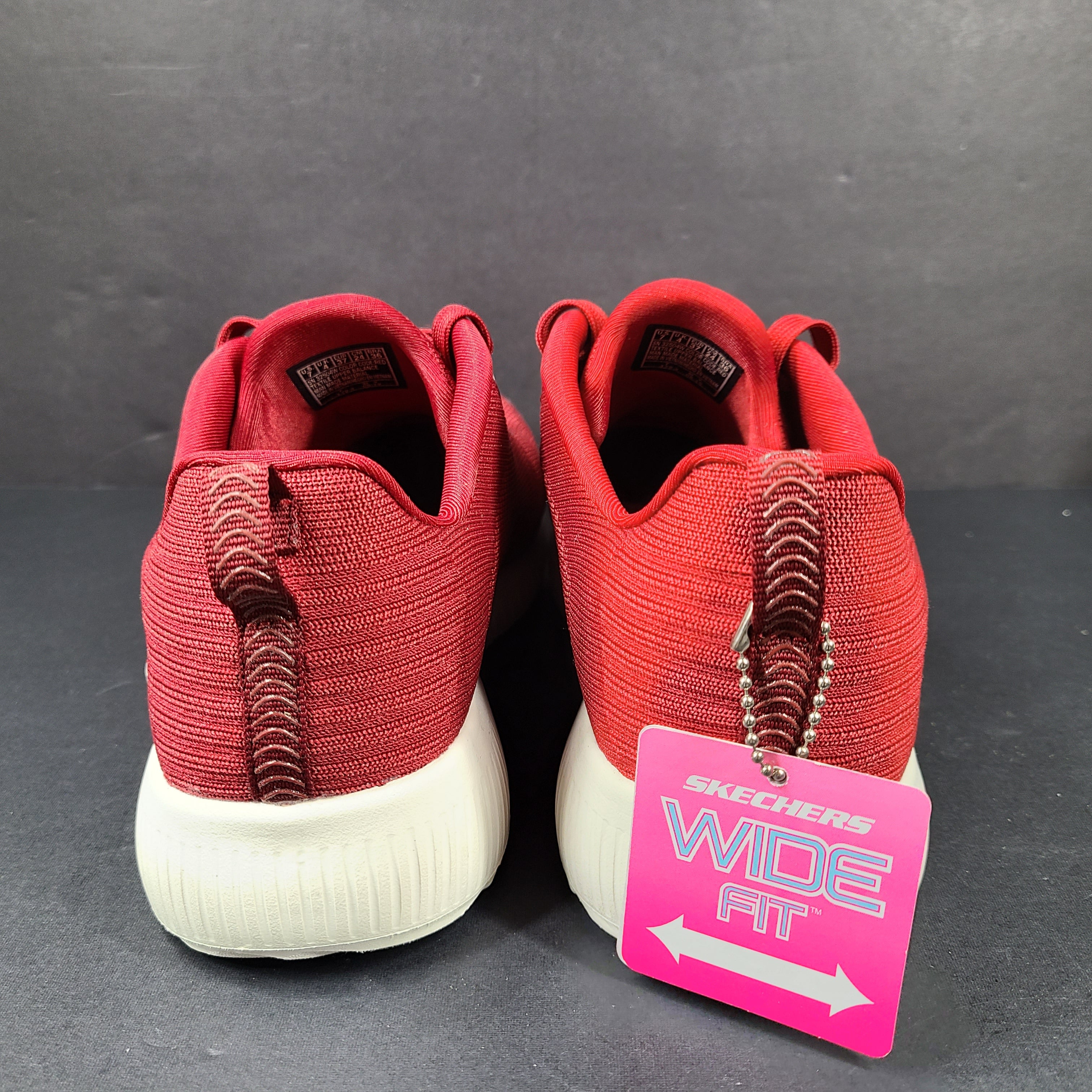 Red Skechers BOBS women's sneaker with cushioned memory foam insole and knit upper for everyday comfort.