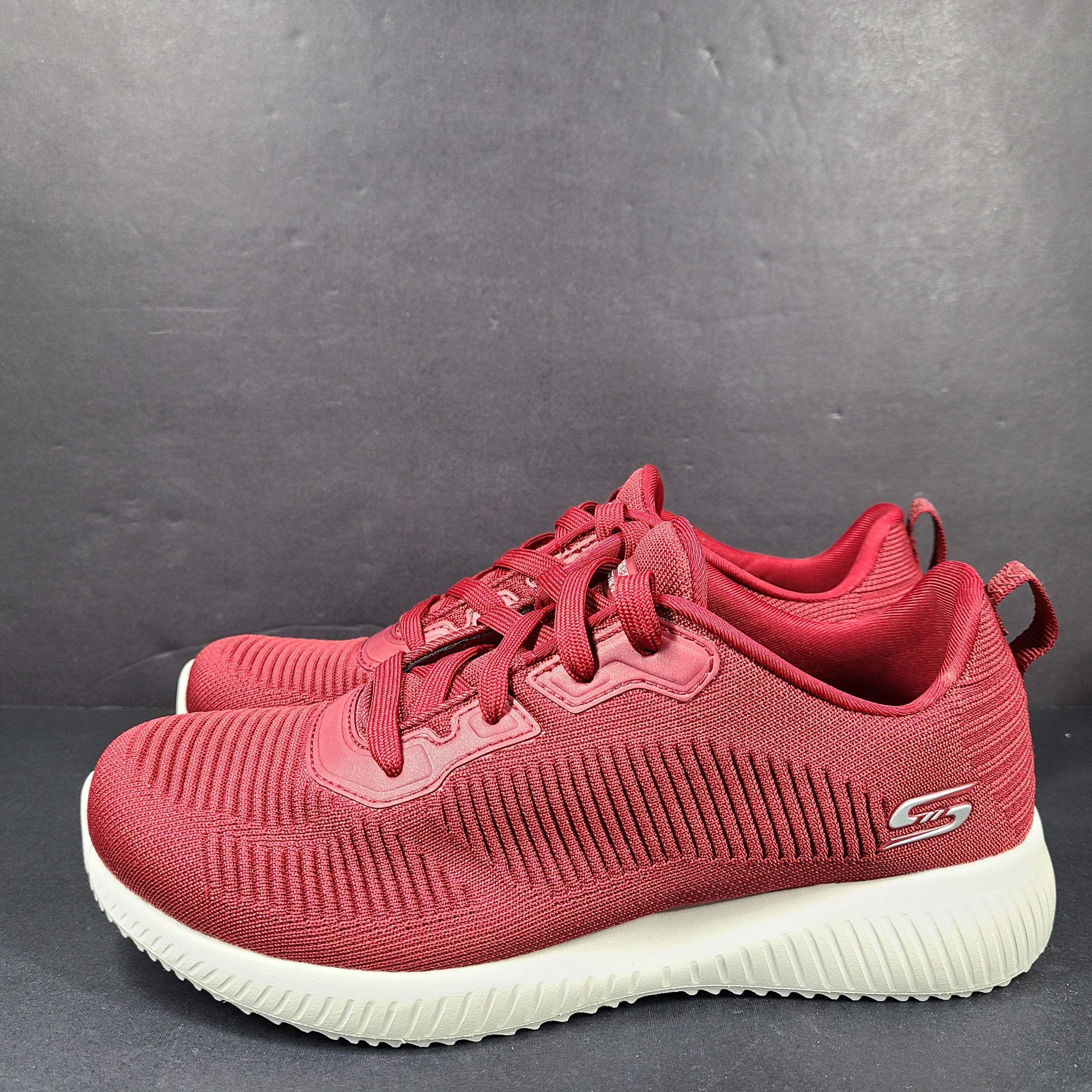 Red Skechers BOBS women's sneaker with cushioned memory foam insole and knit upper for everyday comfort.