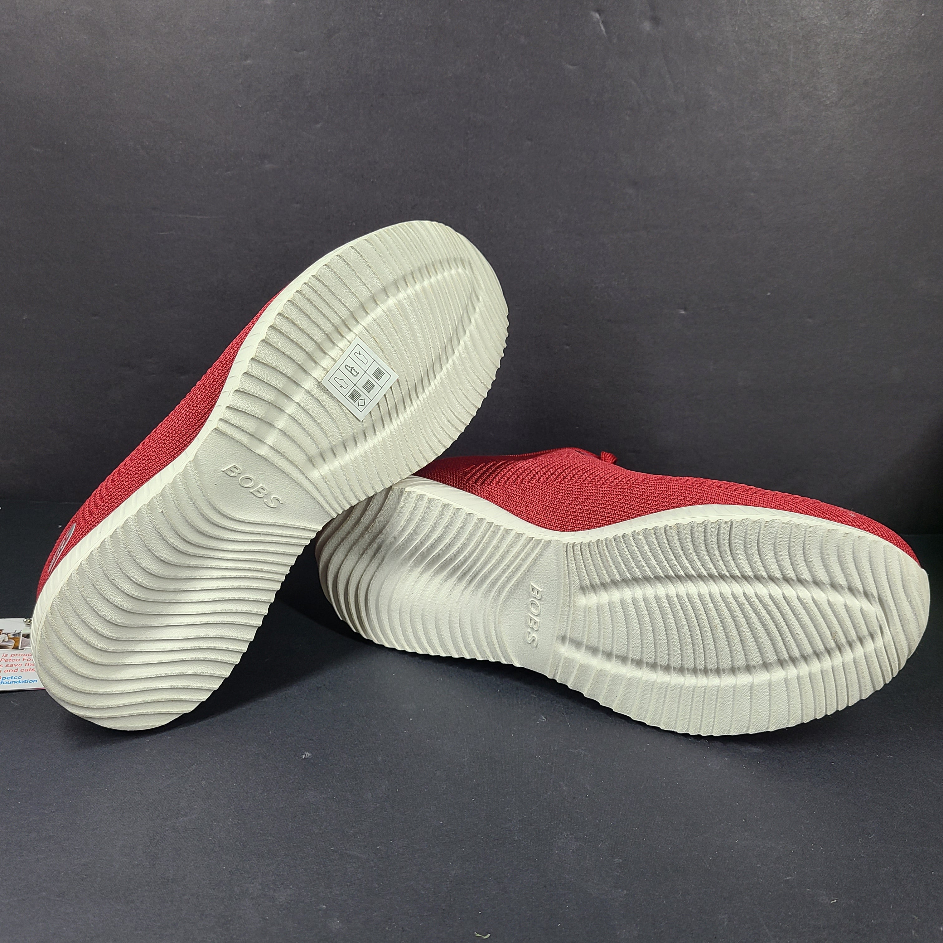 Red Skechers BOBS women's sneaker with cushioned memory foam insole and knit upper for everyday comfort.