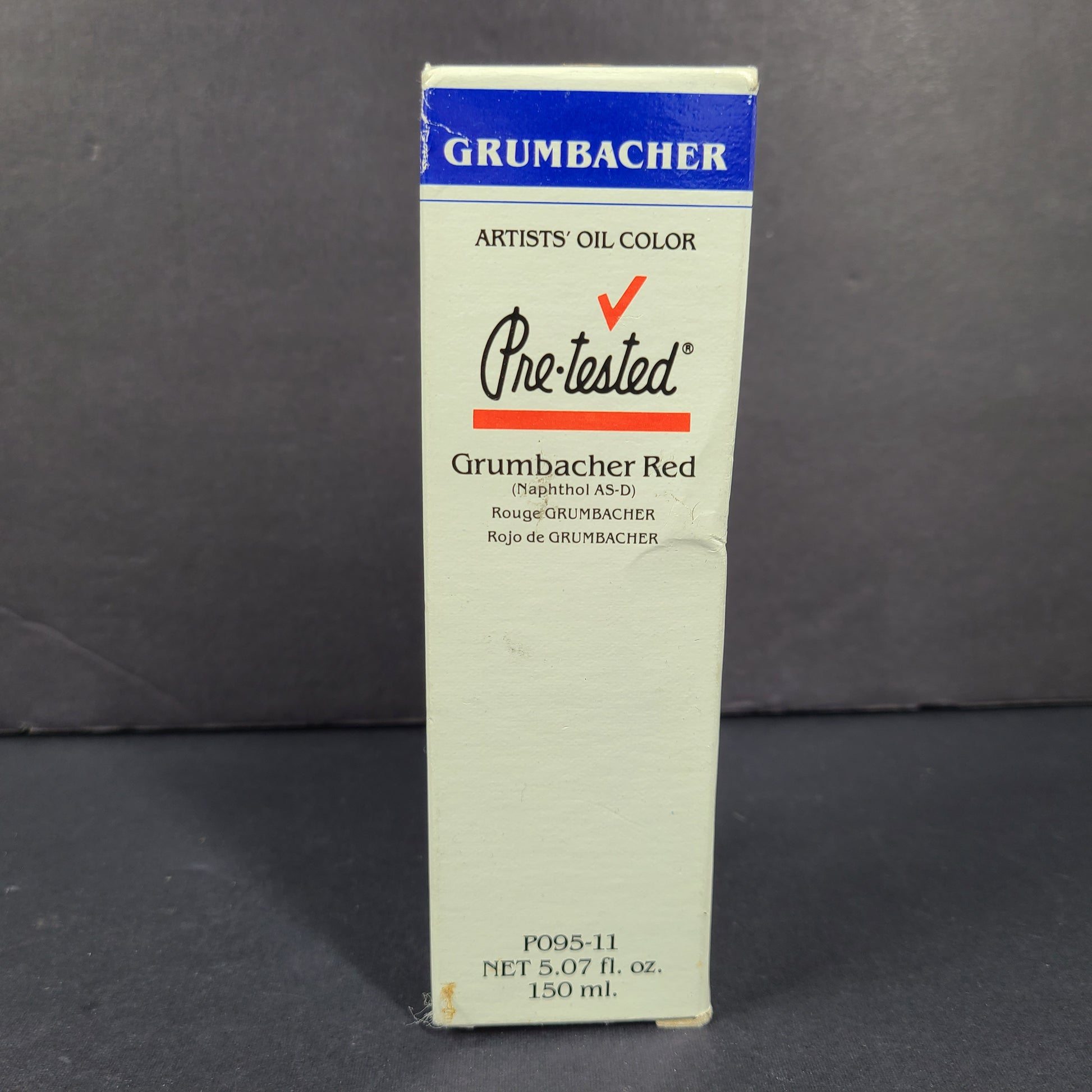 Three artist-grade oil paint colors in cobalt blue, burnt sienna, and red for studio painting.