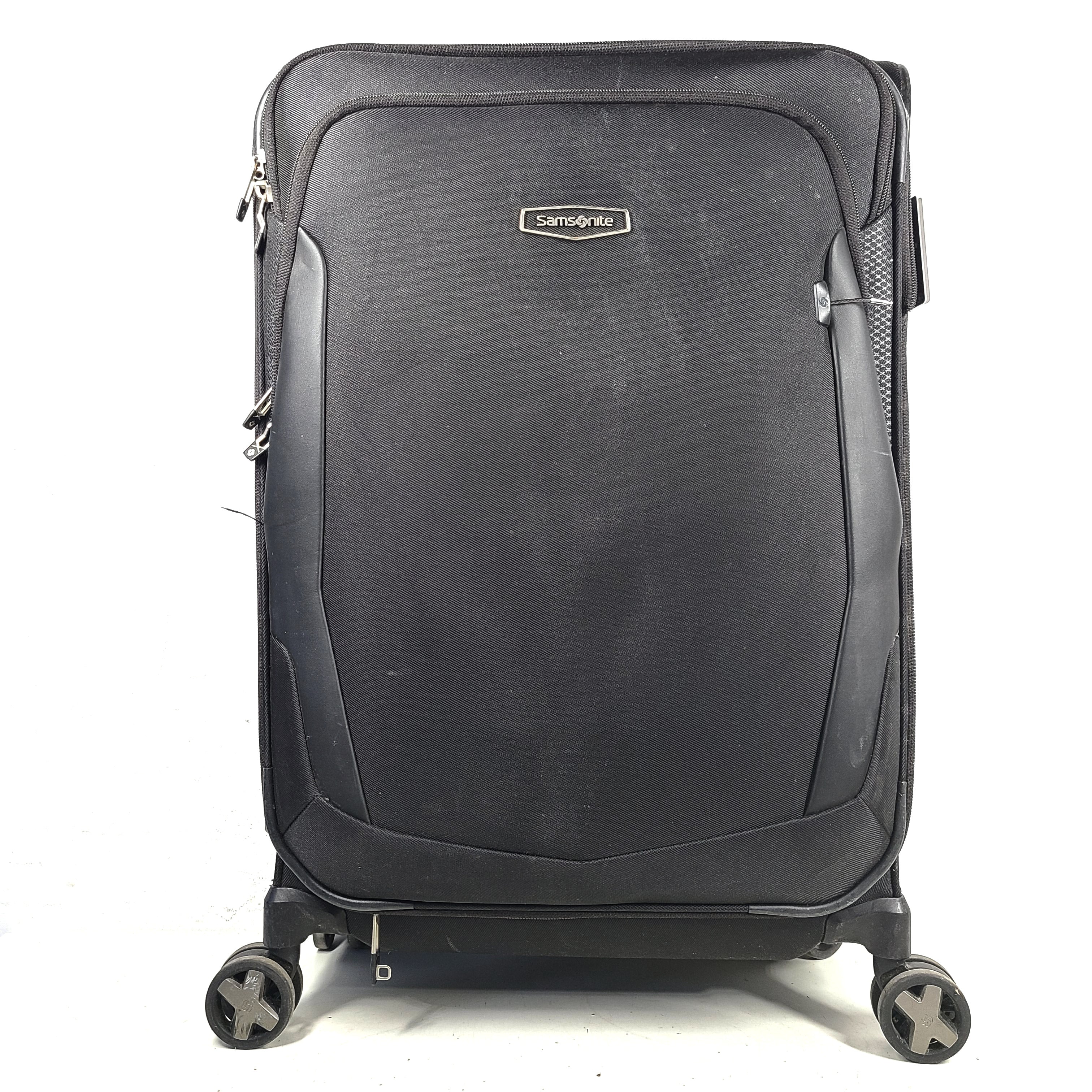 Black Samsonite Spinner 71/26 EXP suitcase with four spinner wheels and a telescoping handle.