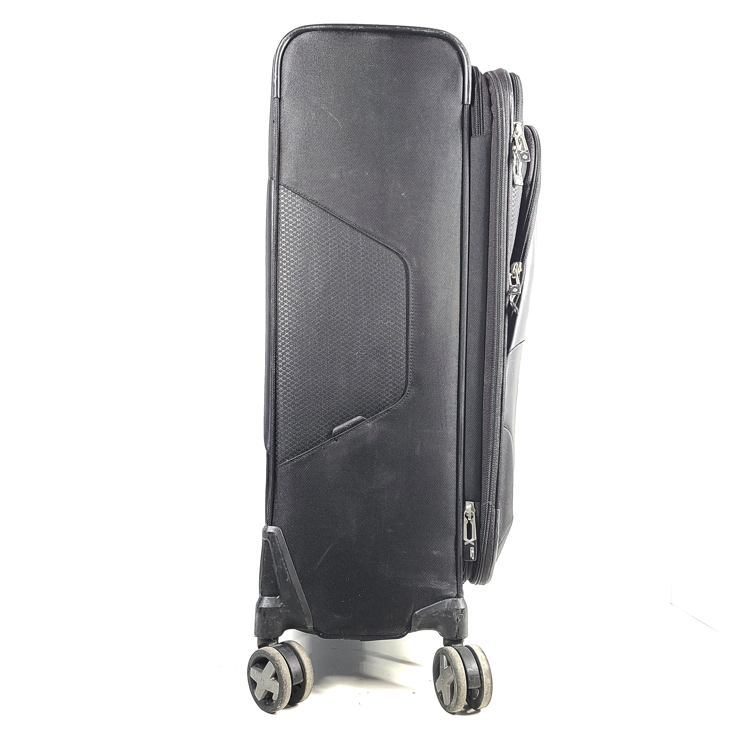 Black Samsonite Spinner 71/26 EXP suitcase with four spinner wheels and a telescoping handle.