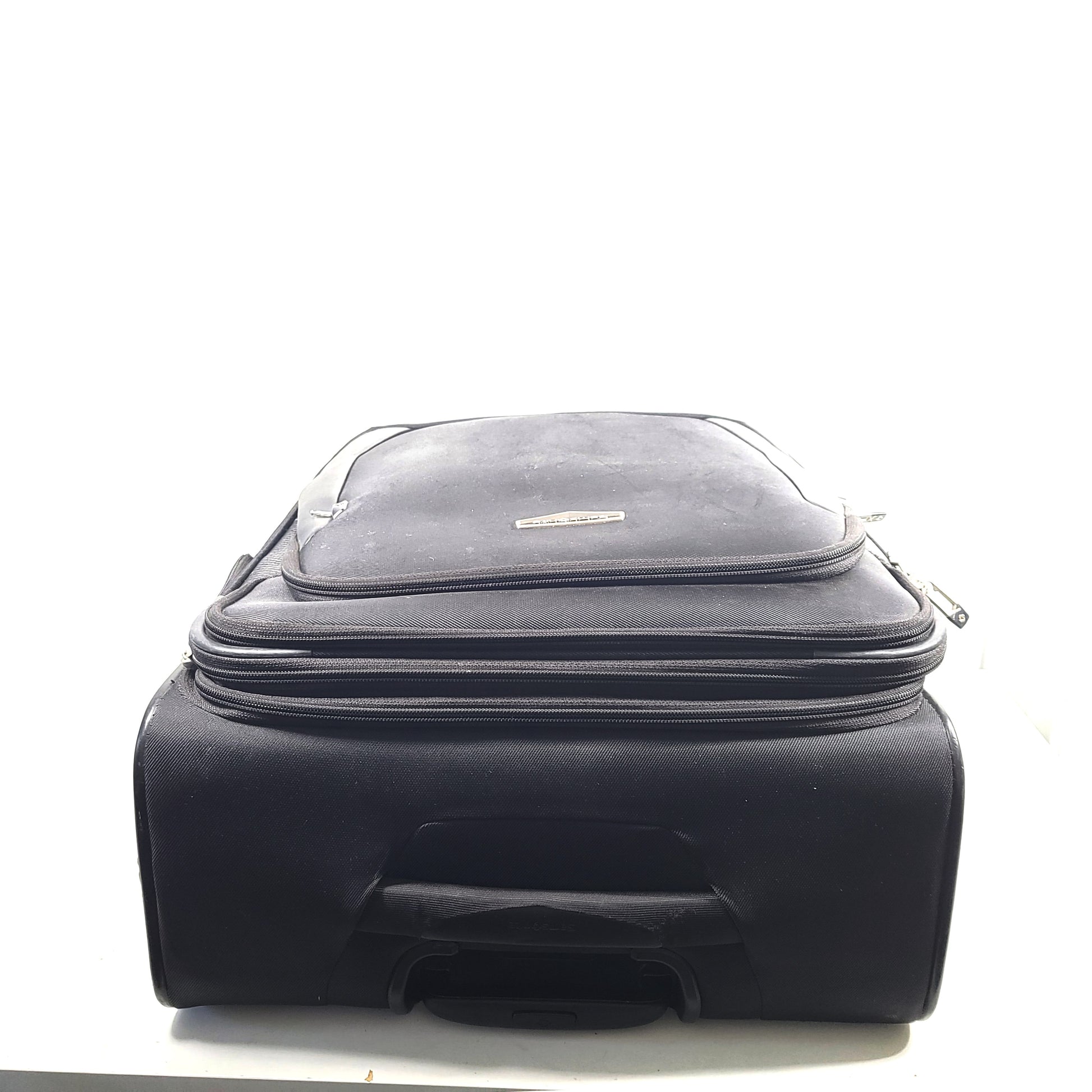 Black Samsonite Spinner 71/26 EXP suitcase with four spinner wheels and a telescoping handle.