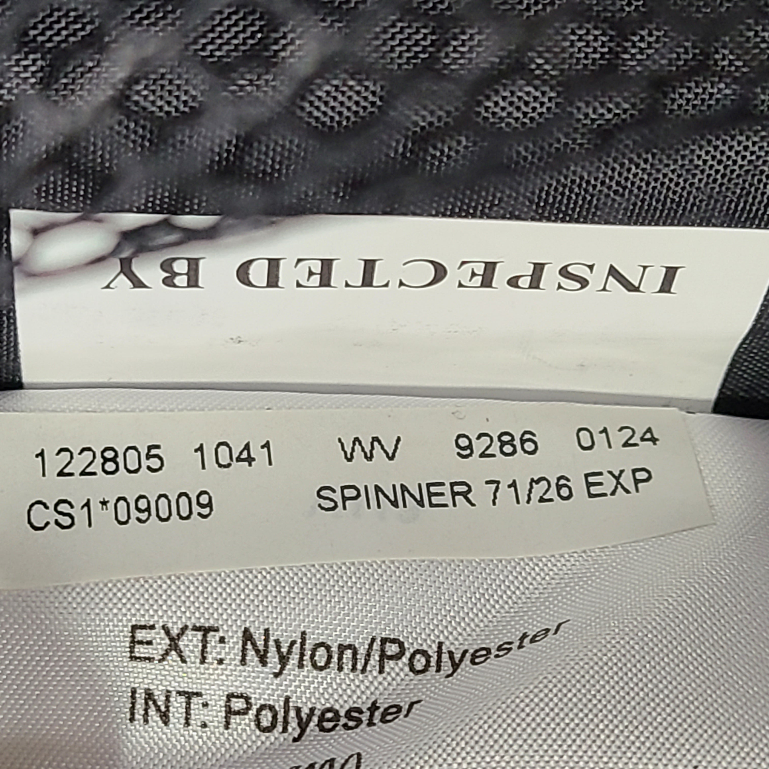 Black Samsonite Spinner 71/26 EXP suitcase with four spinner wheels and a telescoping handle.