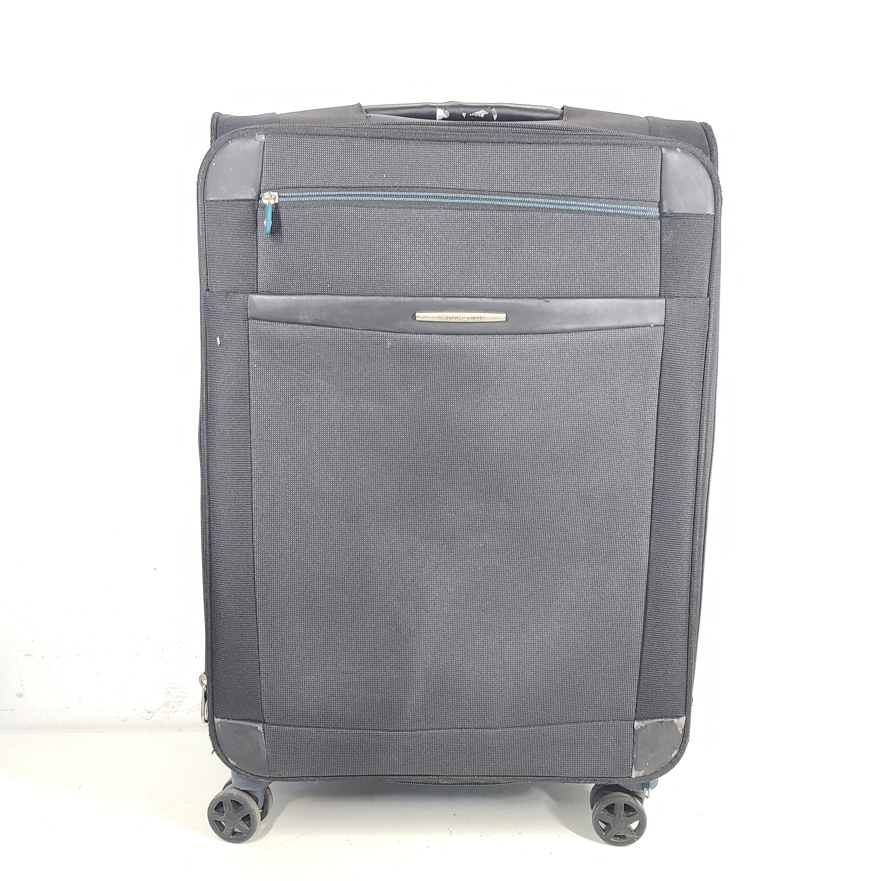Black Samsonite 67/24 EXP spinner suitcase with scuffs and marks on the exterior.