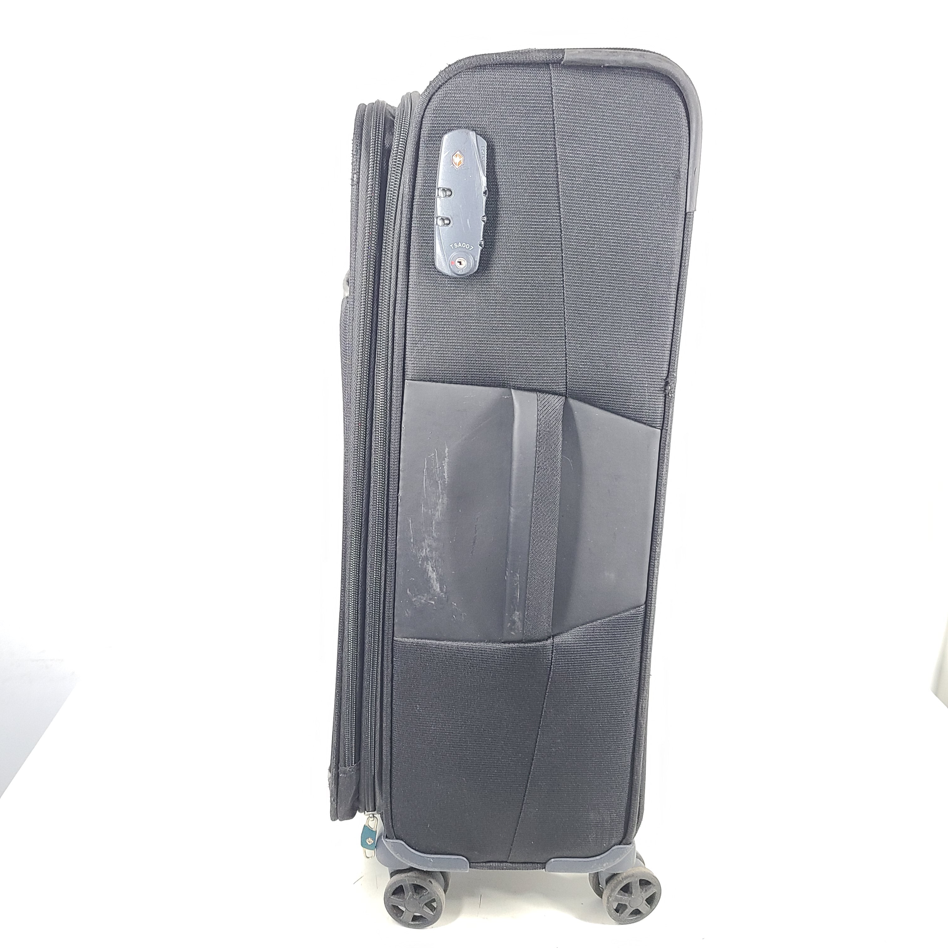 Black Samsonite 67/24 EXP spinner suitcase with scuffs and marks on the exterior.