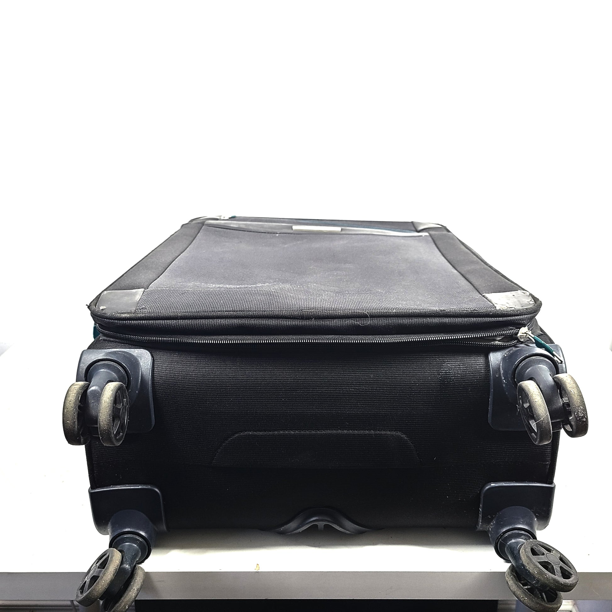 Black Samsonite 67/24 EXP spinner suitcase with scuffs and marks on the exterior.