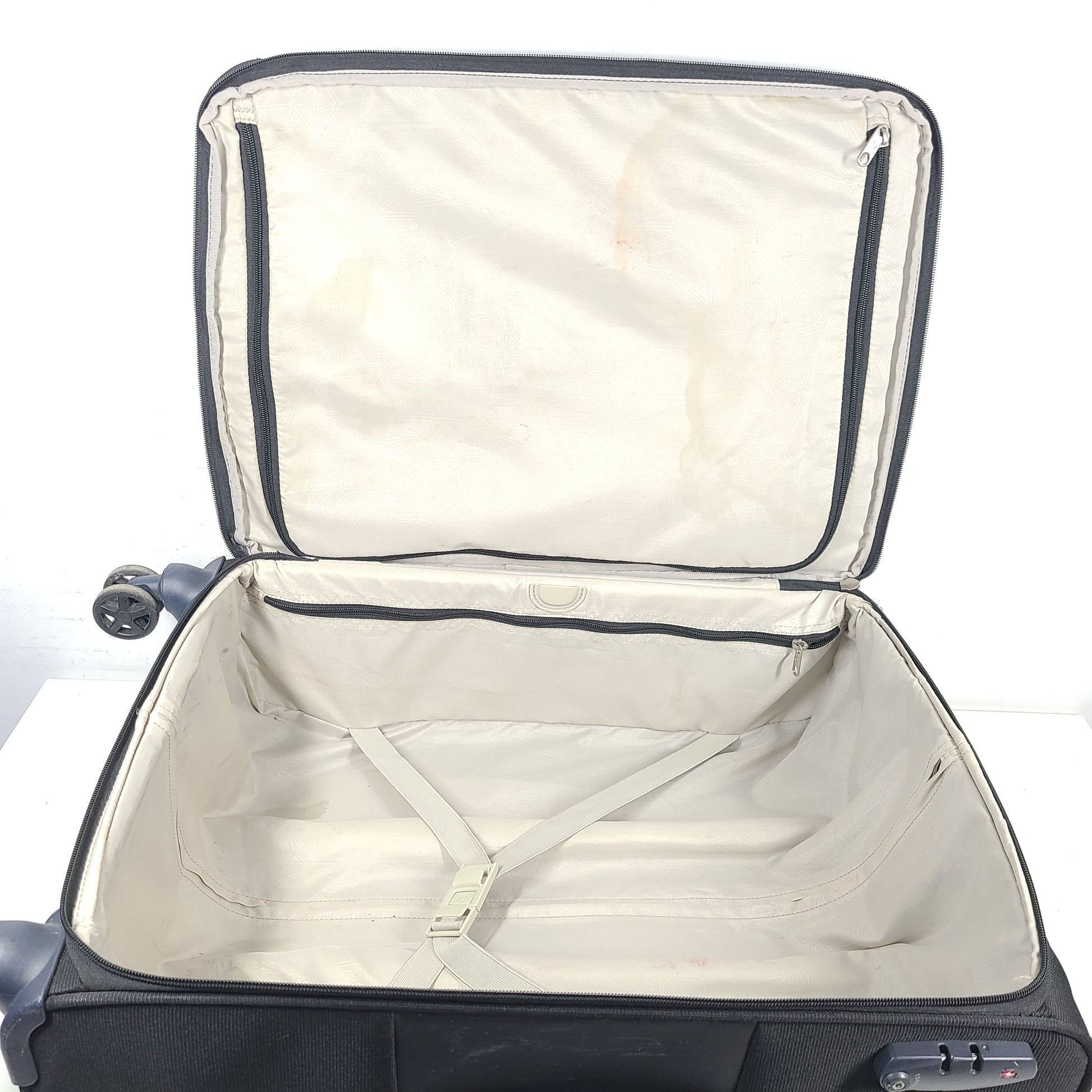 Black Samsonite 67/24 EXP spinner suitcase with scuffs and marks on the exterior.