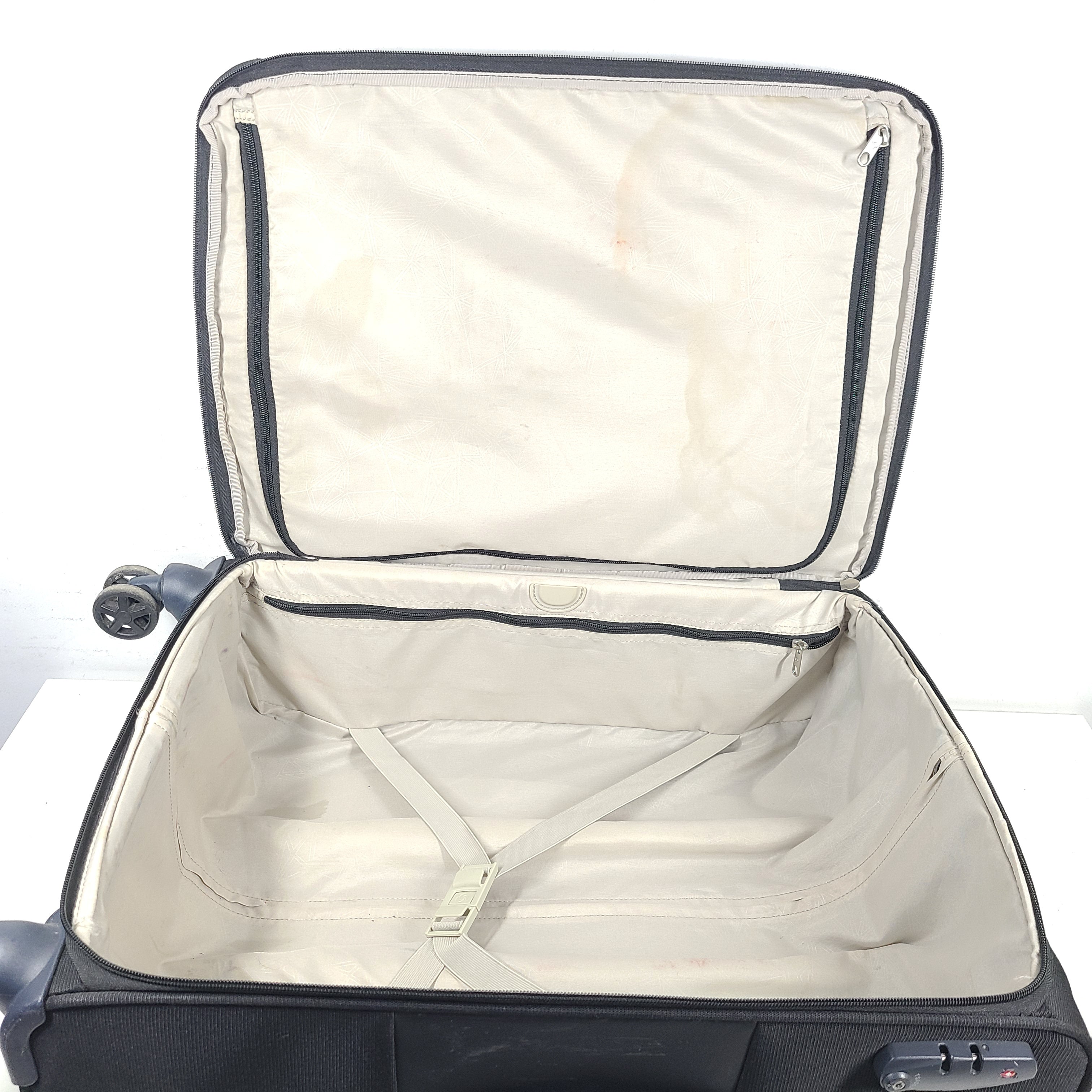 Black Samsonite 67/24 EXP spinner suitcase with scuffs and marks on the exterior.
