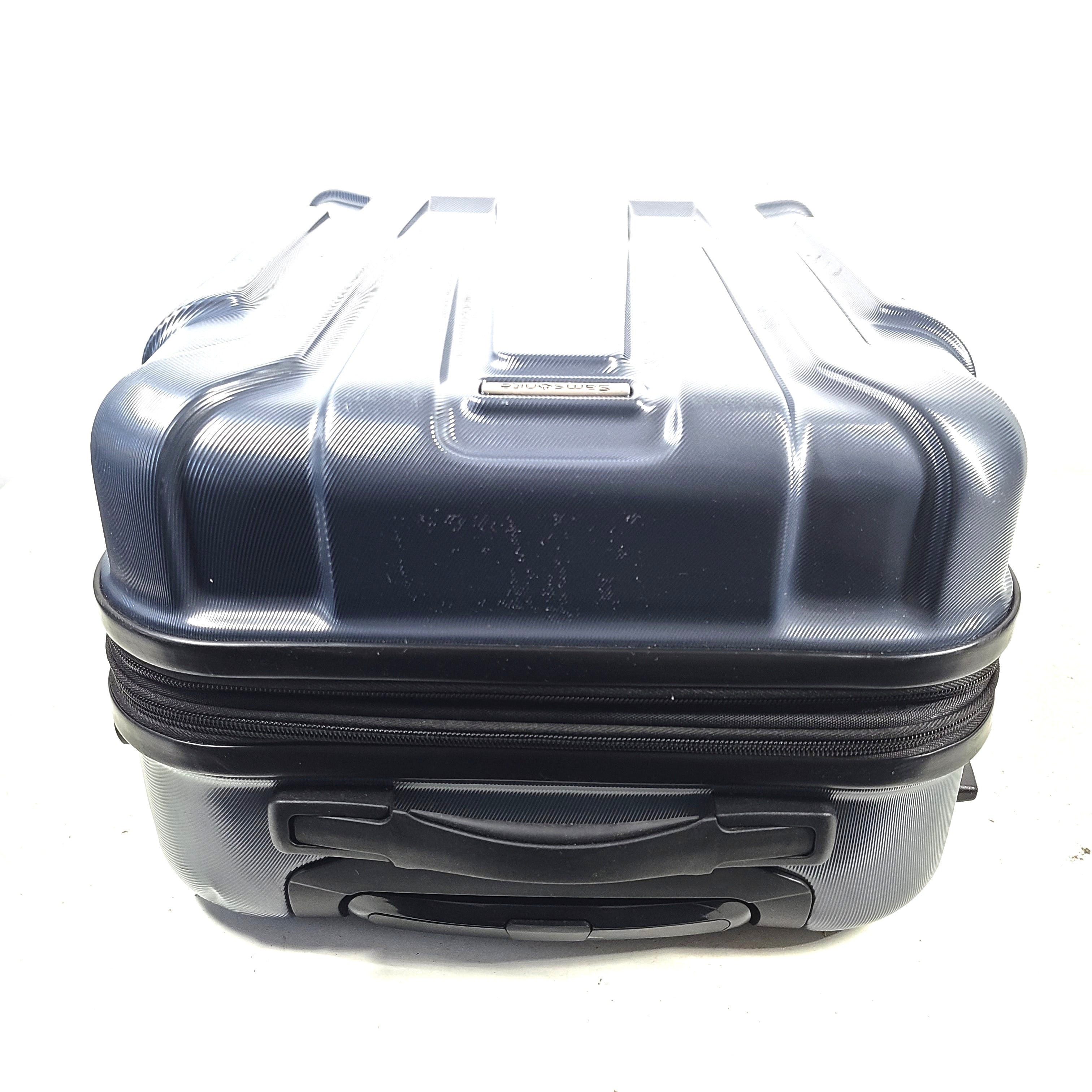 Blue Samsonite 8853 hard-shell spinner suitcase with exterior scuffs and a clean interior.