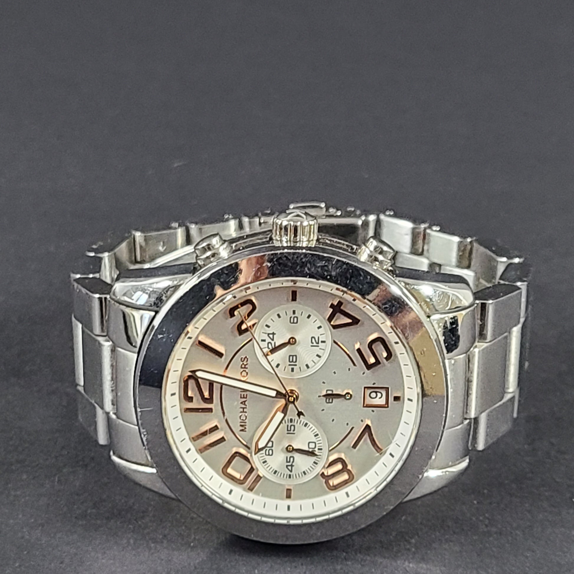 Michael Kors Mercer MK-5725 stainless steel chronograph wristwatch with a silver dial and 42mm case.