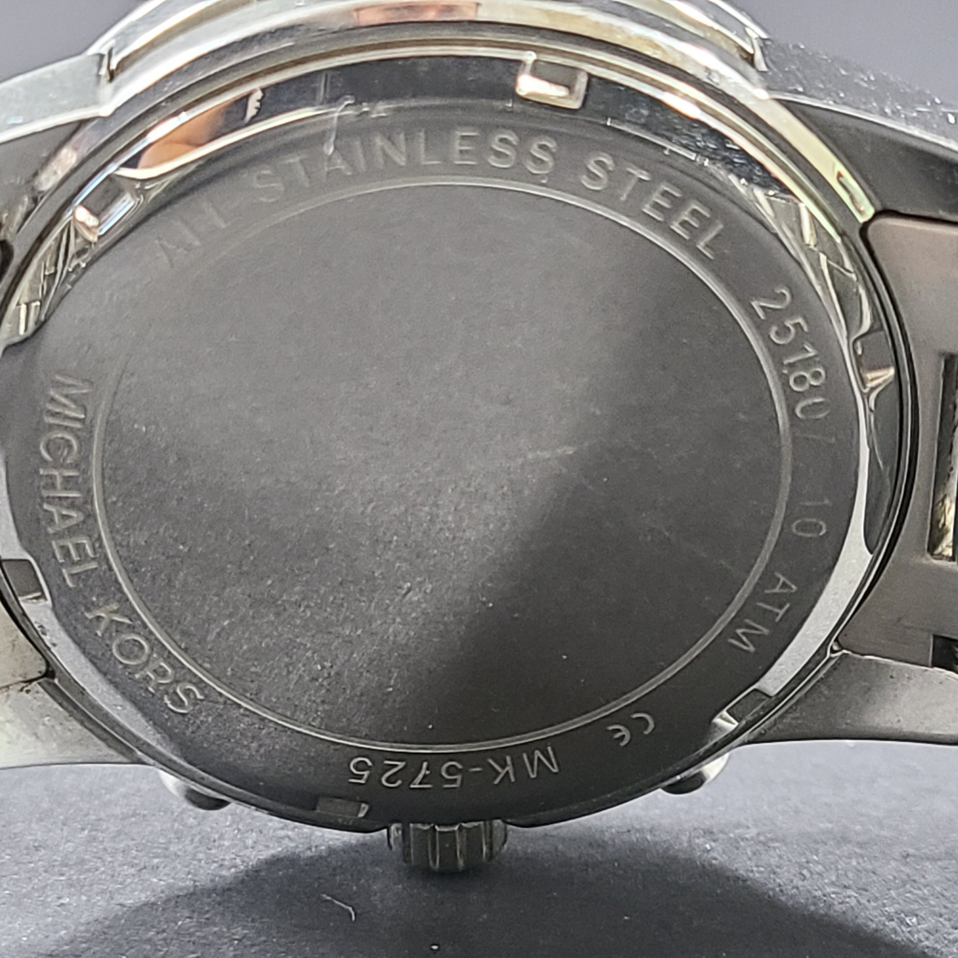 Michael Kors Mercer MK-5725 stainless steel chronograph wristwatch with a silver dial and 42mm case.