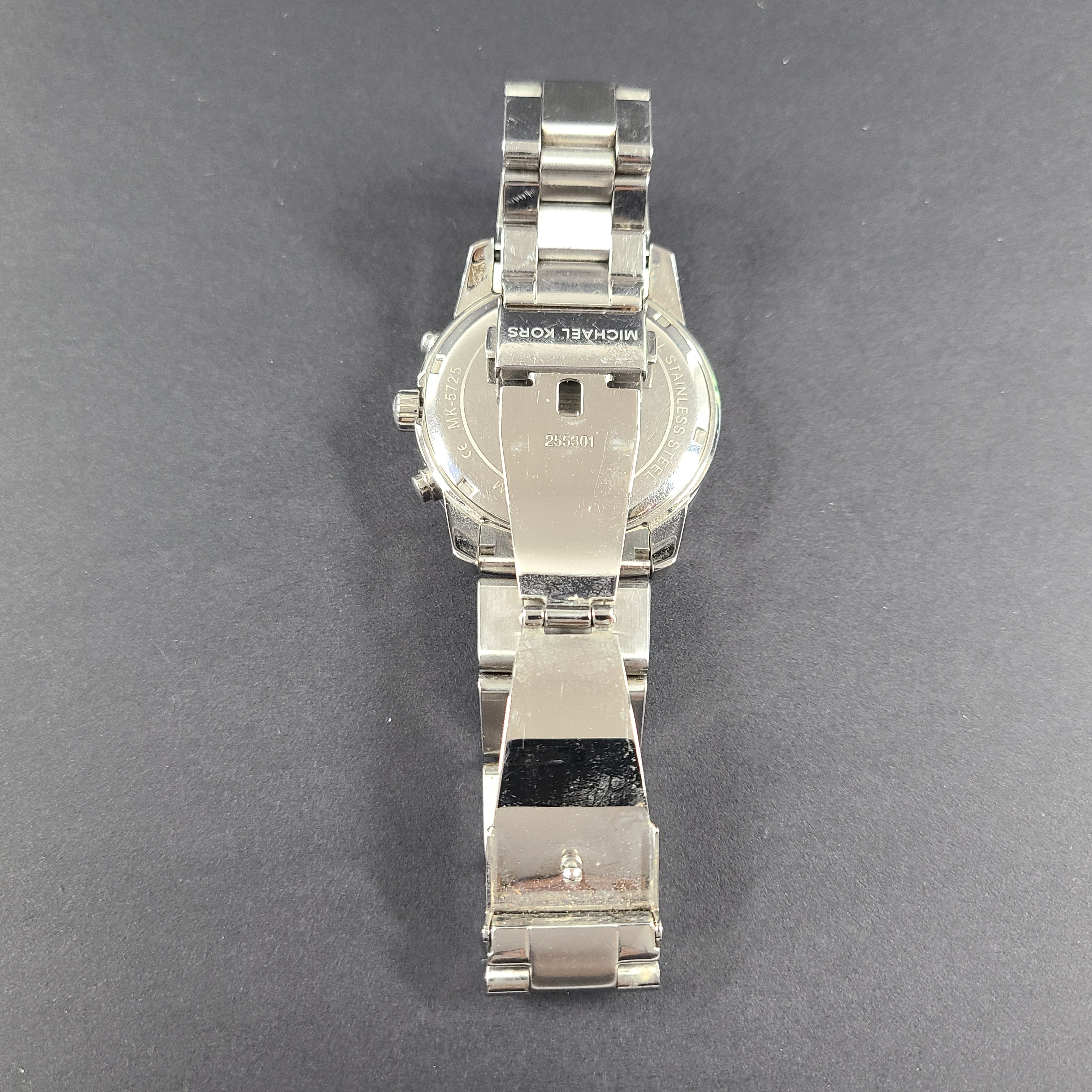 Michael Kors Mercer MK-5725 stainless steel chronograph wristwatch with a silver dial and 42mm case.