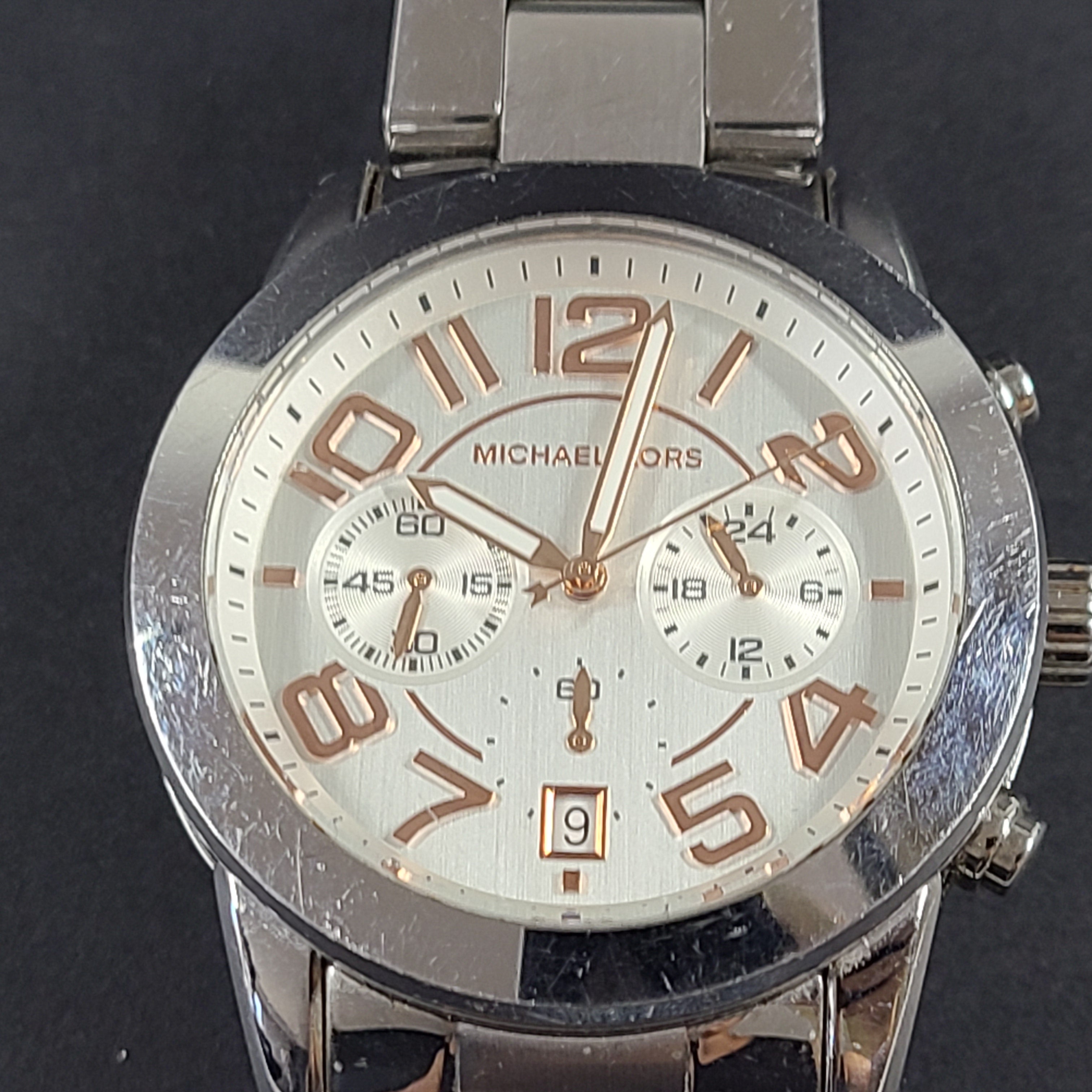 Michael Kors Mercer MK-5725 stainless steel chronograph wristwatch with a silver dial and 42mm case.