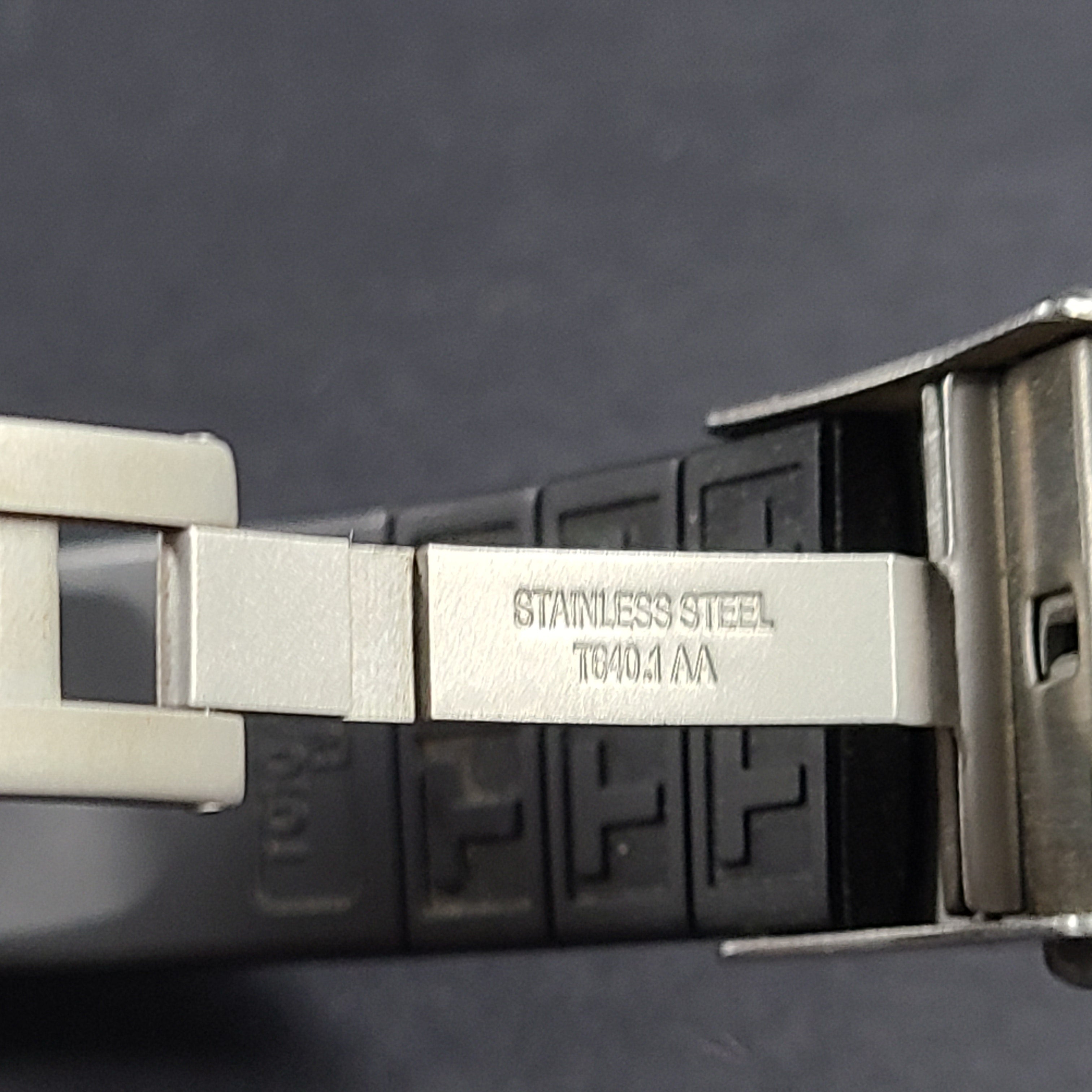Tissot T Navigator 3000 stainless steel wristwatch with black dial and metal bracelet.