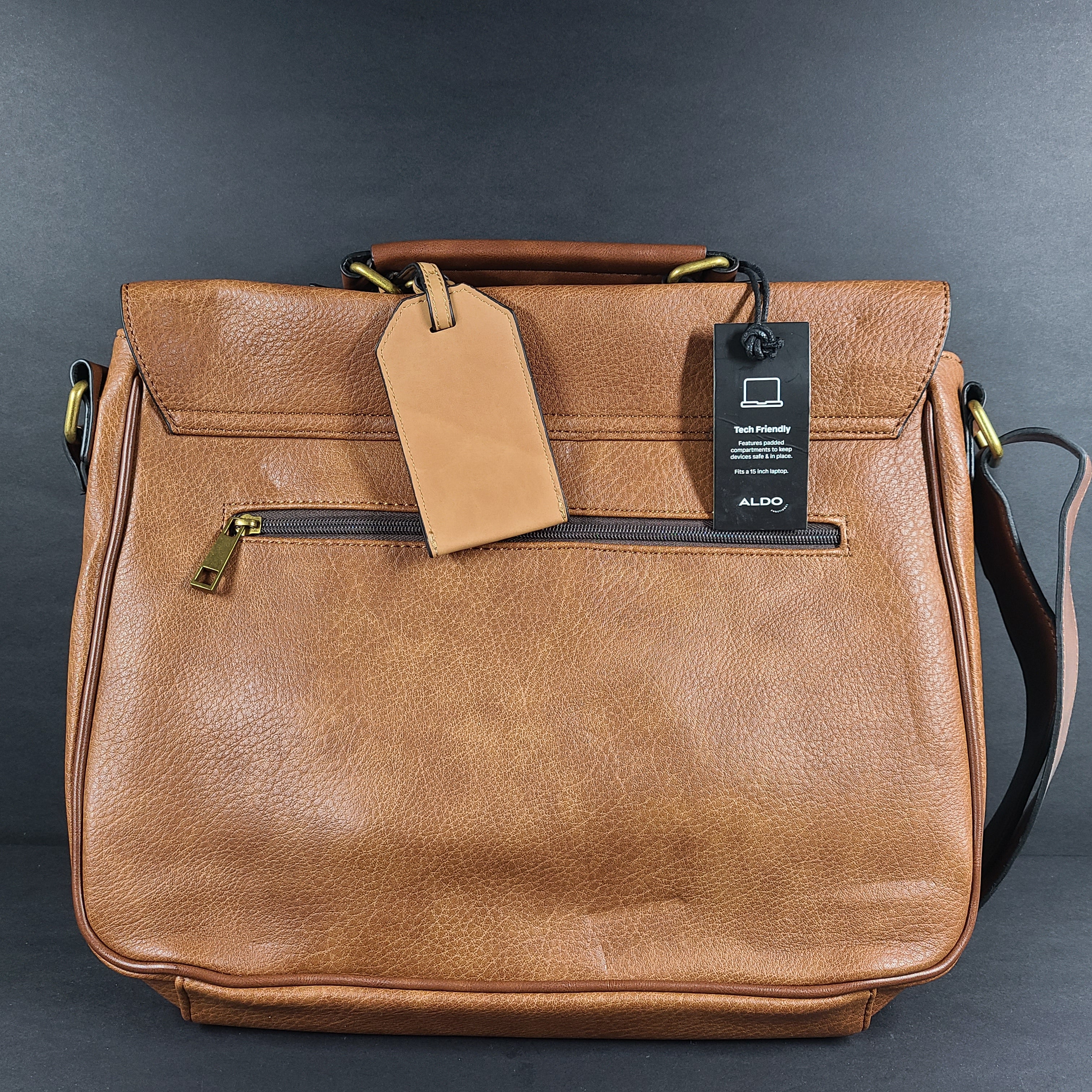 Brown ALDO messenger bag with adjustable strap and luggage tag designed to carry up to a 15-inch laptop.