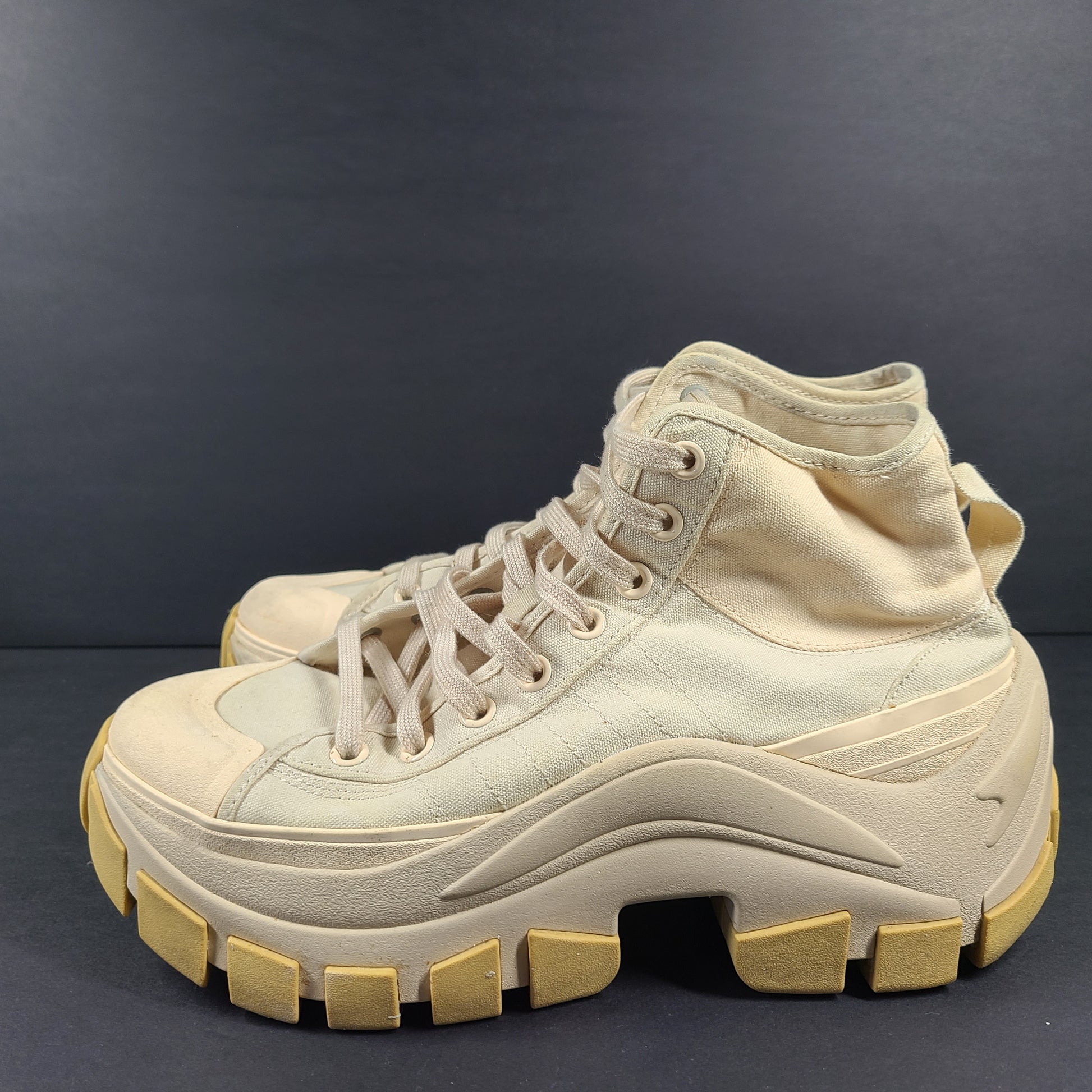 Adidas Nizza Hi XY22 beige high-top sneakers with a platform profile and gum outsole.