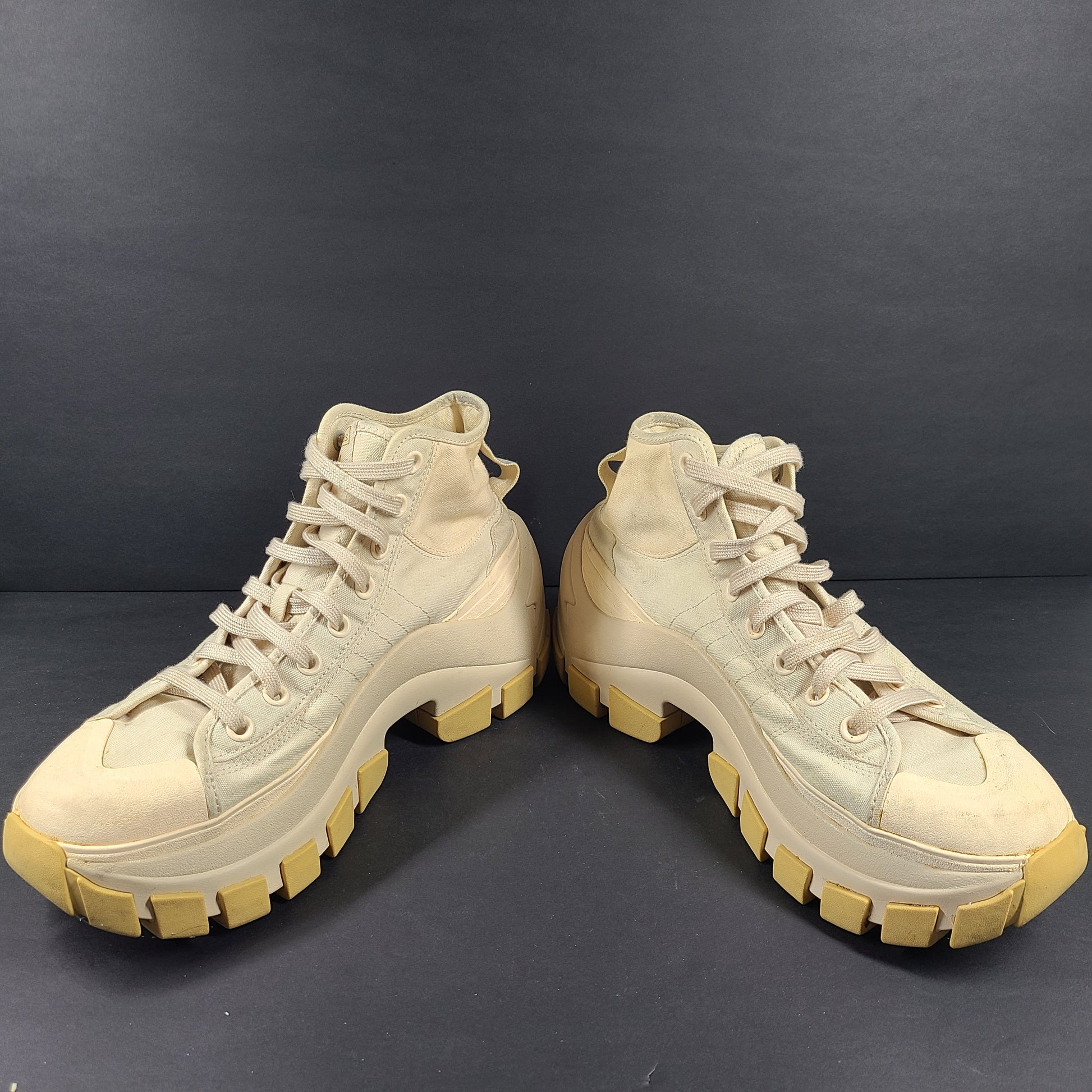 Adidas Nizza Hi XY22 beige high-top sneakers with a platform profile and gum outsole.