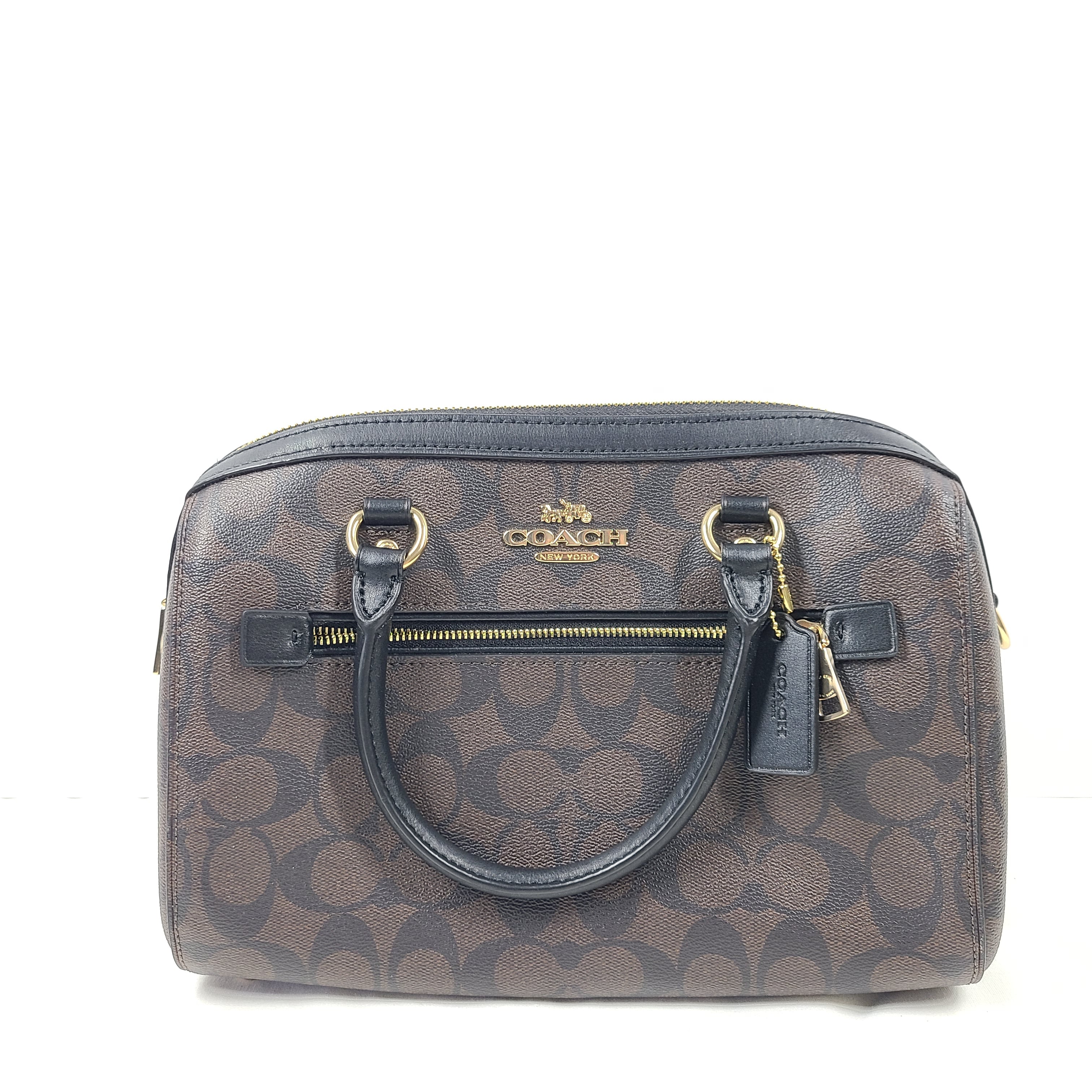Compact Coach Bennett mini satchel in brown and black with a detachable strap for versatile carry.