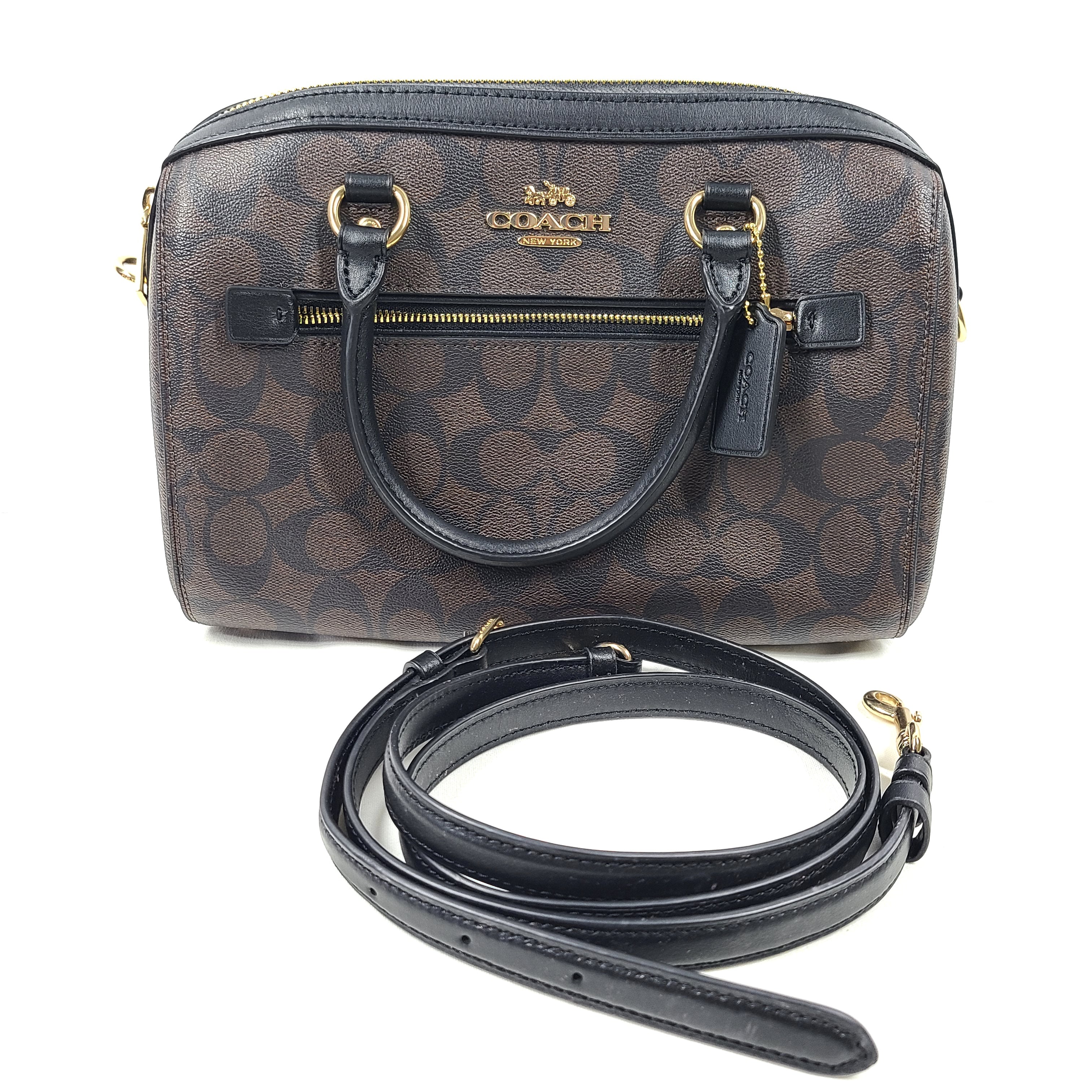 Compact Coach Bennett mini satchel in brown and black with a detachable strap for versatile carry.