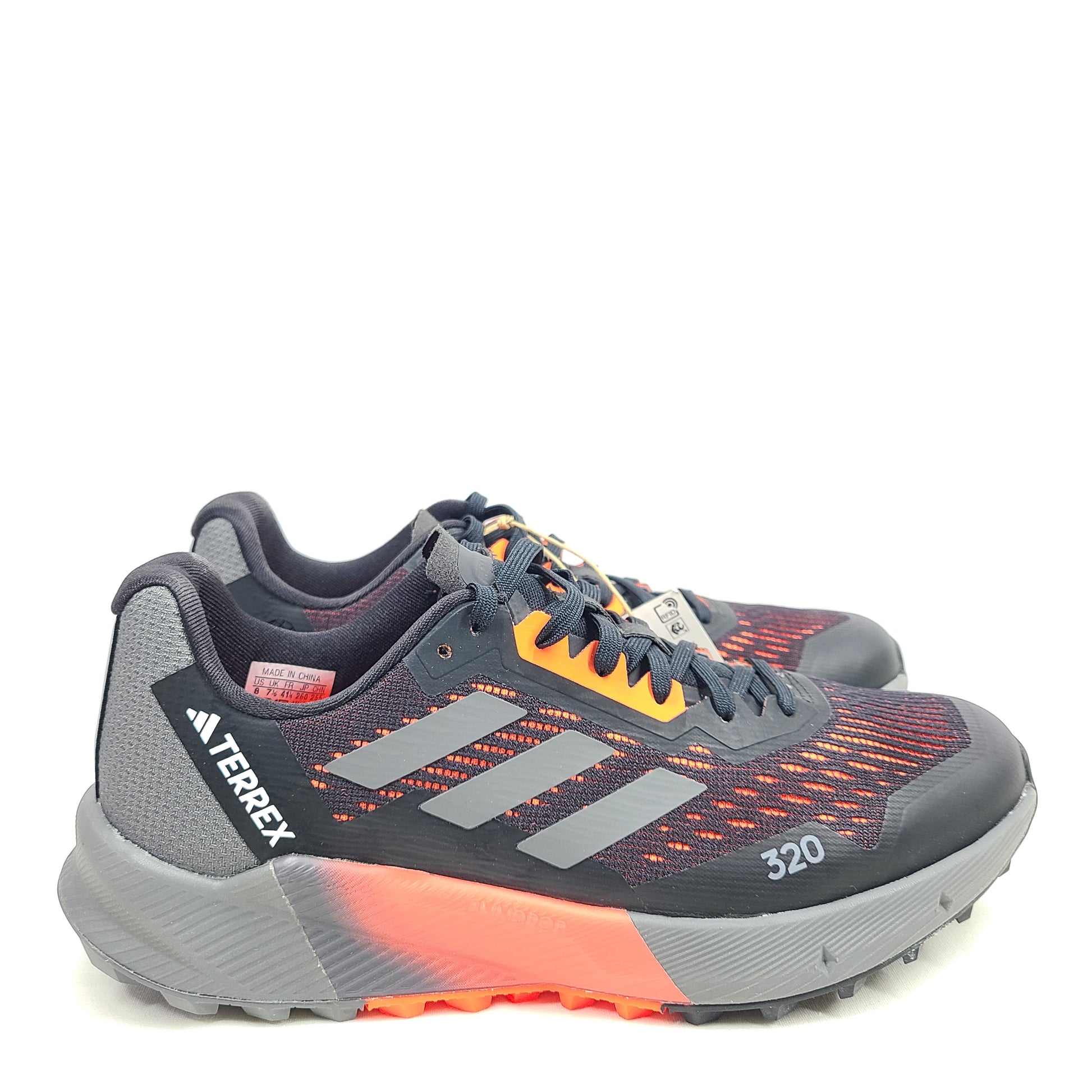 Black, orange, and gray Adidas Terrex Agravic Flow trail running shoe in US size 8 with responsive cushioning and a grippy outsole.