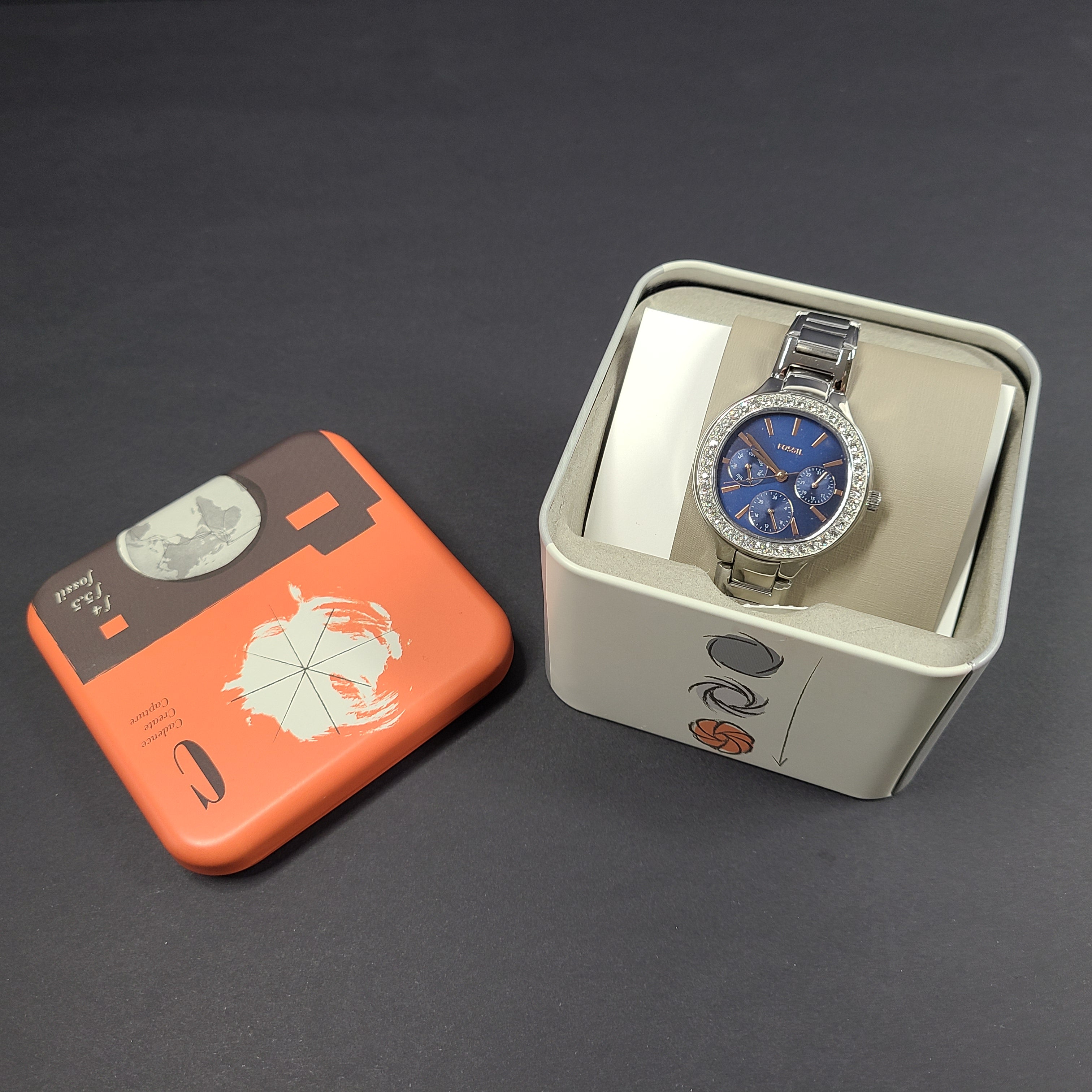 Sleek stainless-steel Fossil wristwatch with a blue dial and a slim 9mm case.