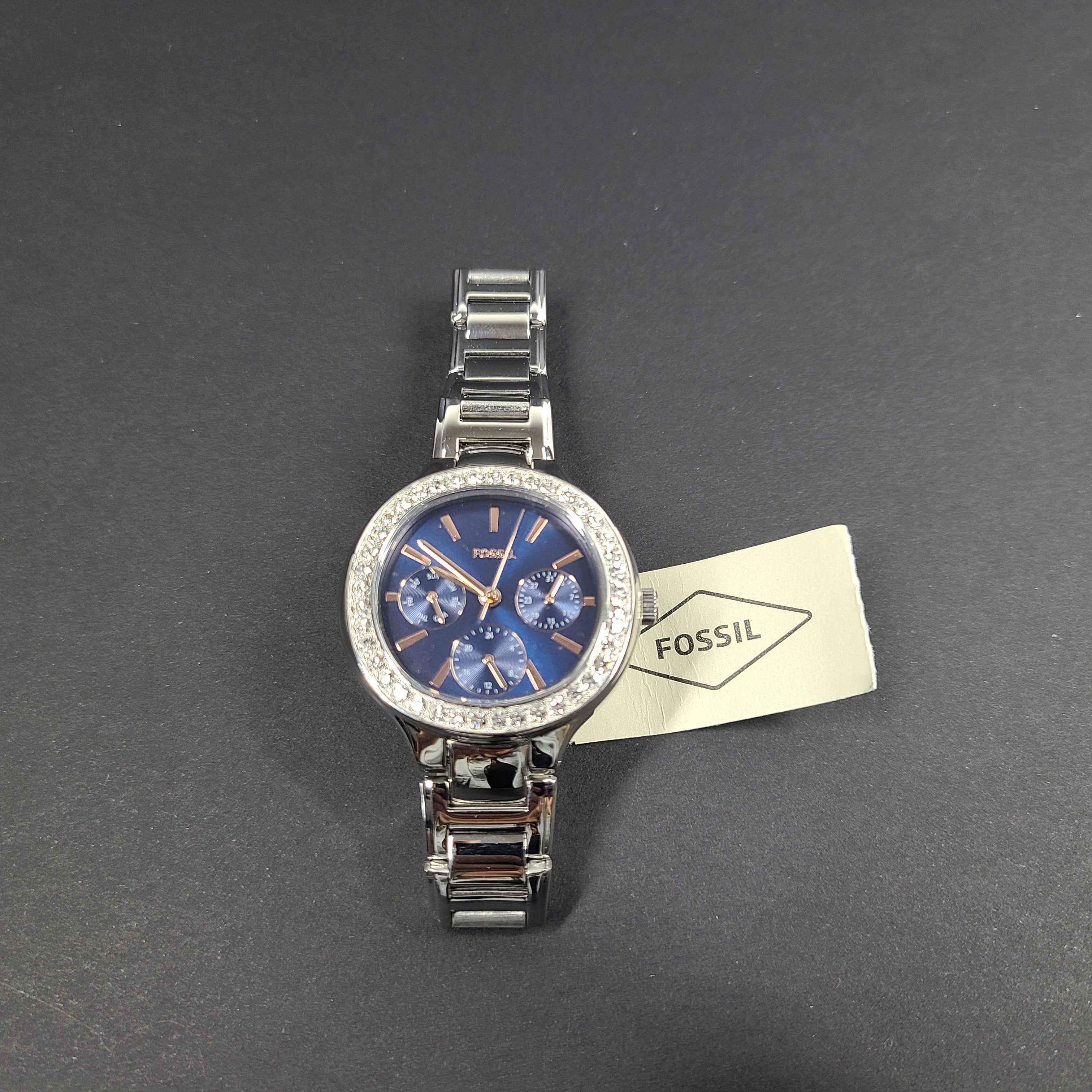 Sleek stainless-steel Fossil wristwatch with a blue dial and a slim 9mm case.