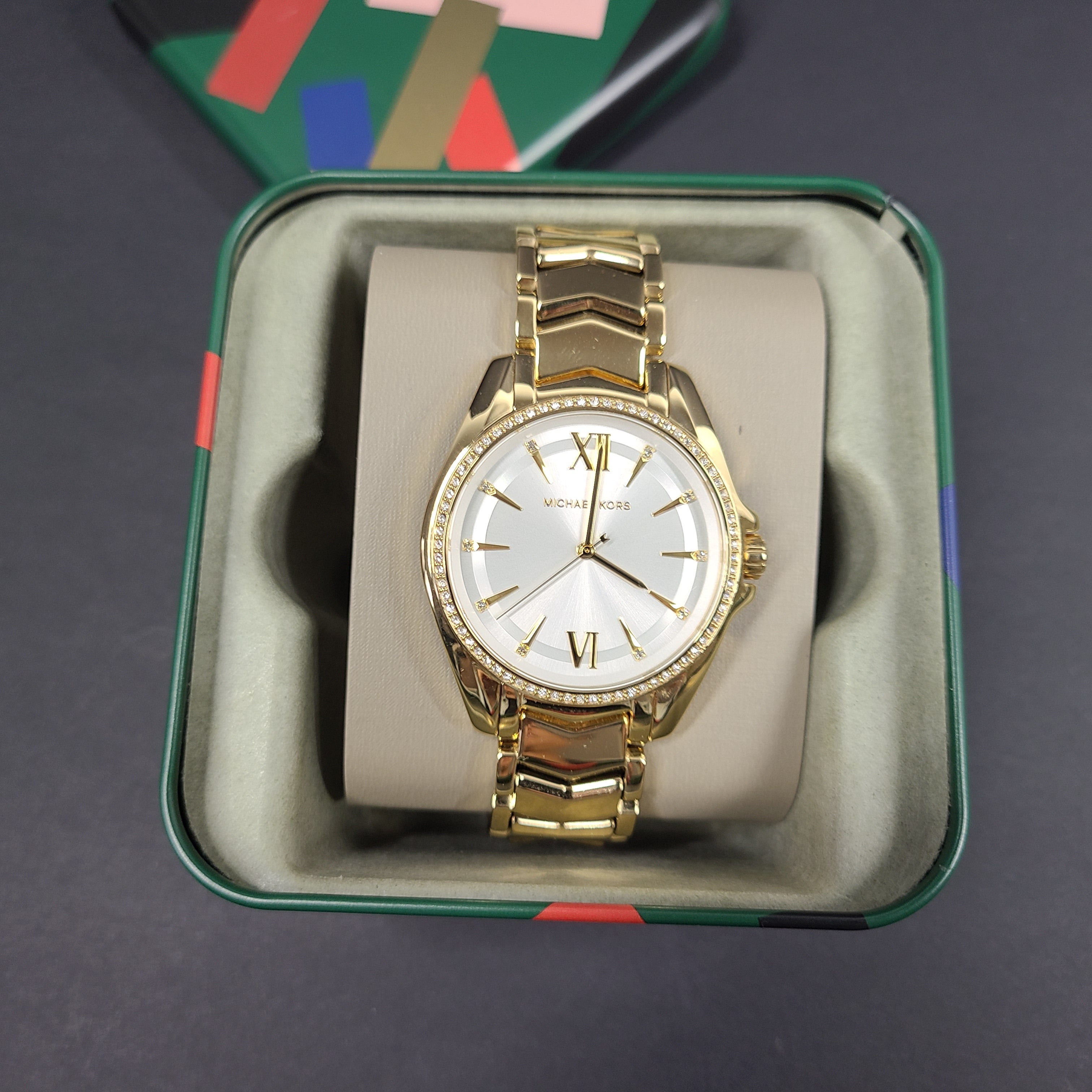 Gold-tone Michael Kors MK6692 women's analog stainless steel watch with white dial and linked bracelet.