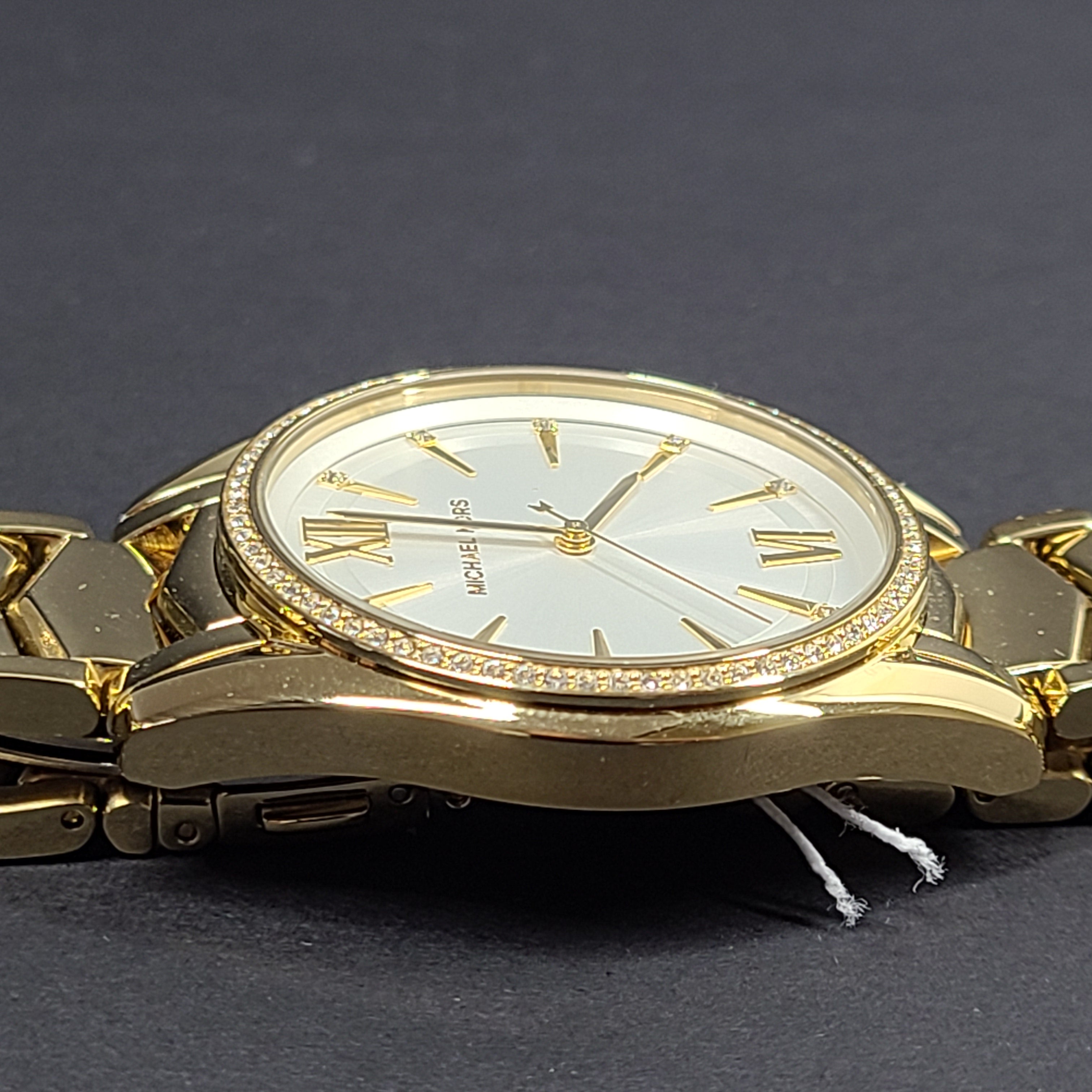 Gold-tone Michael Kors MK6692 women's analog stainless steel watch with white dial and linked bracelet.