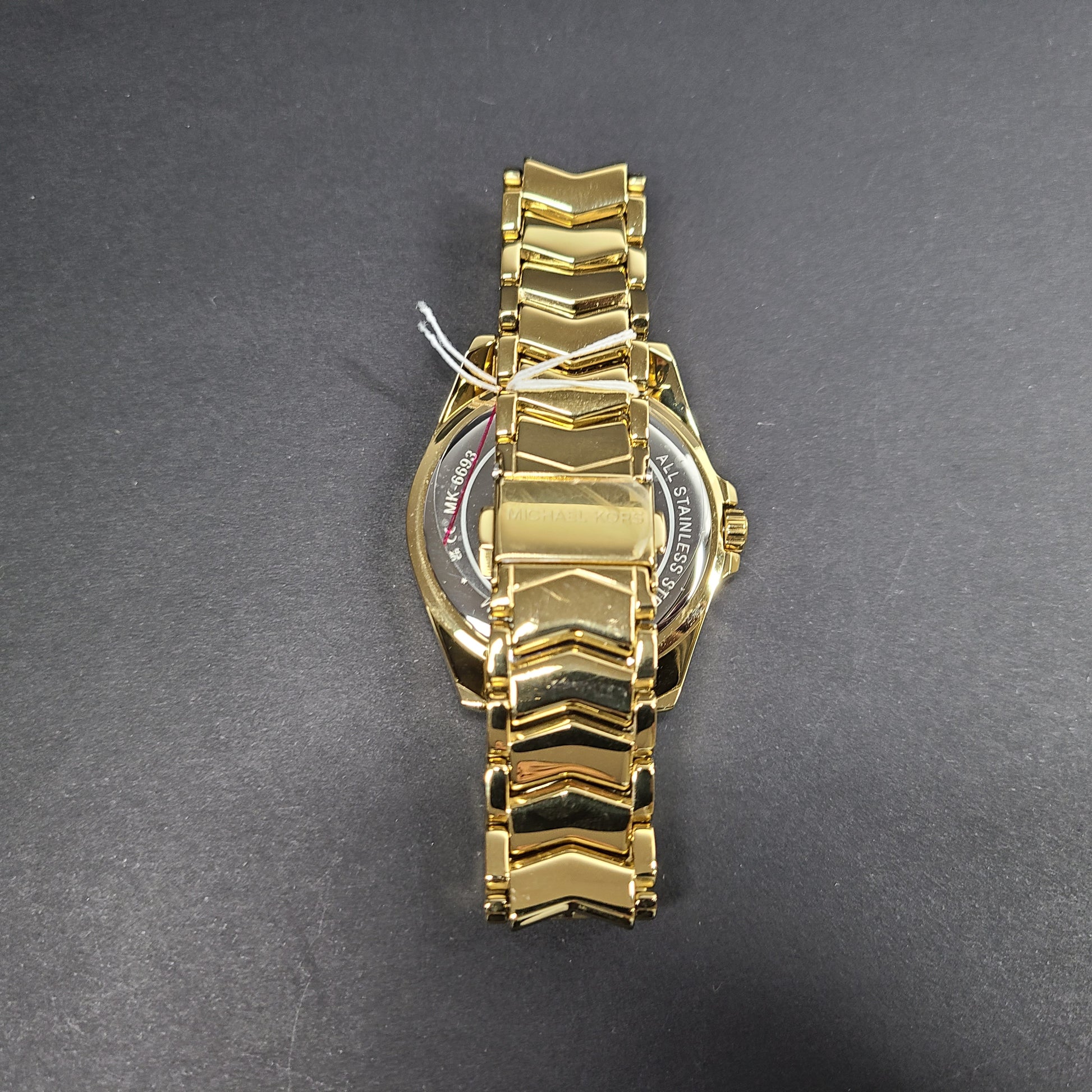 Gold-tone Michael Kors MK6692 women's analog stainless steel watch with white dial and linked bracelet.
