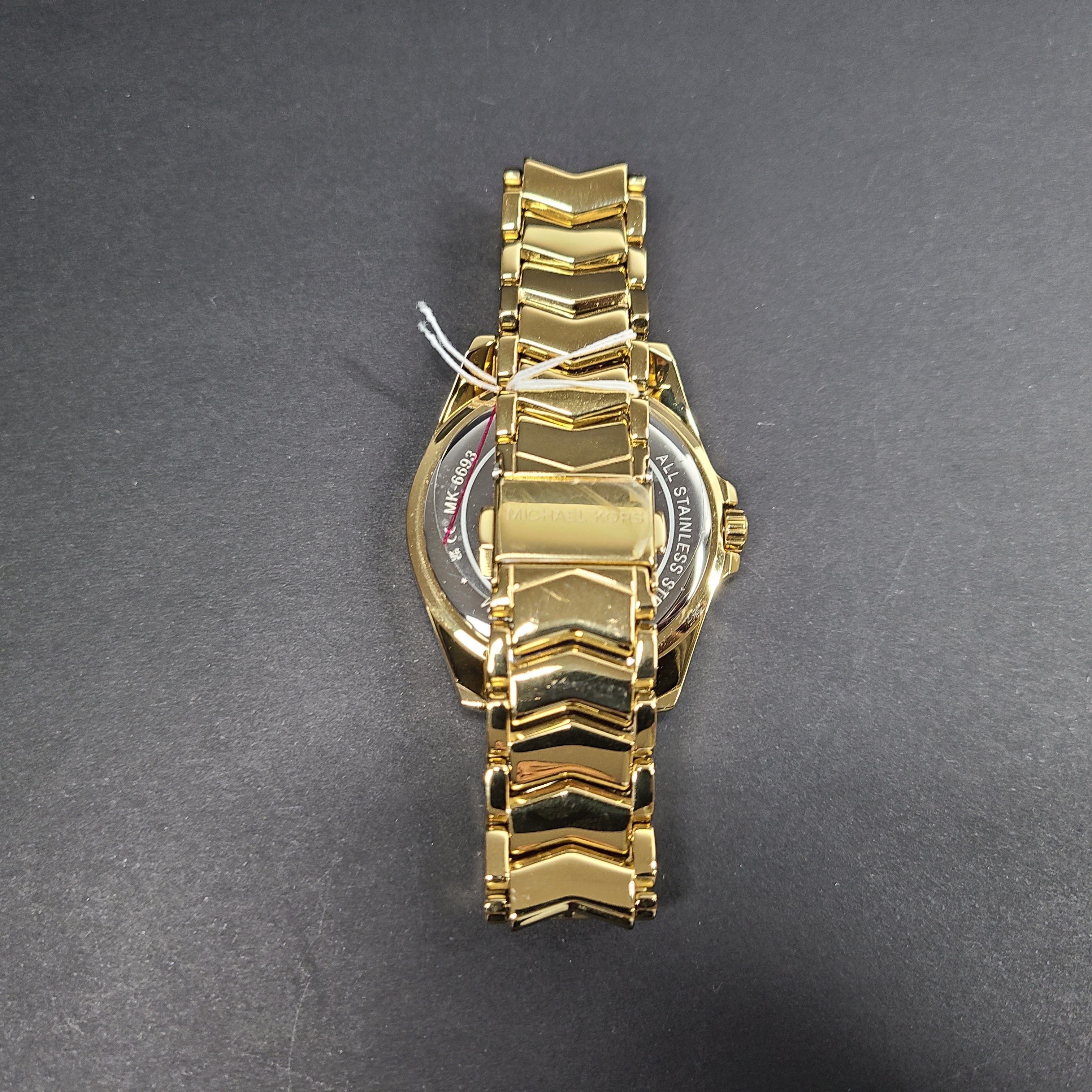Gold-tone Michael Kors MK6692 women's analog stainless steel watch with white dial and linked bracelet.