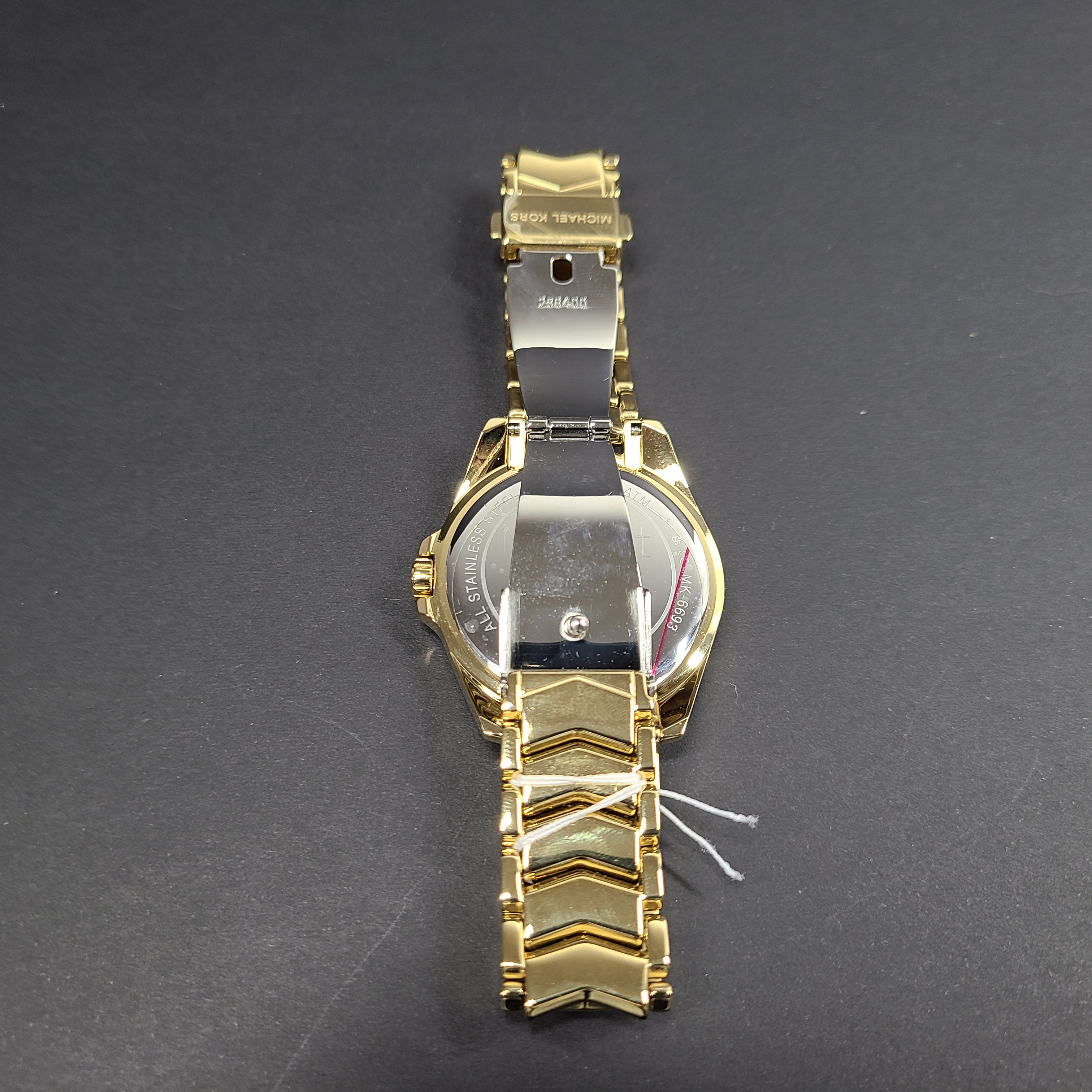 Gold-tone Michael Kors MK6692 women's analog stainless steel watch with white dial and linked bracelet.