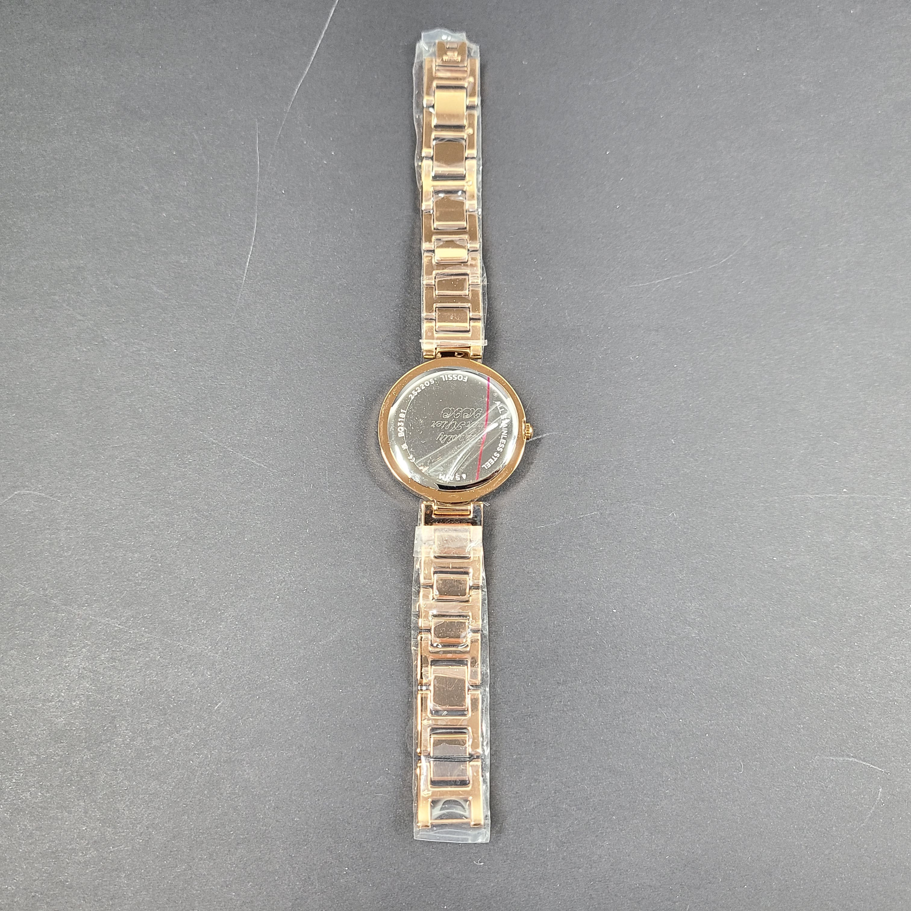 Rose gold Fossil Karli three-hand stainless steel watch with a minimalist round dial and bracelet band.