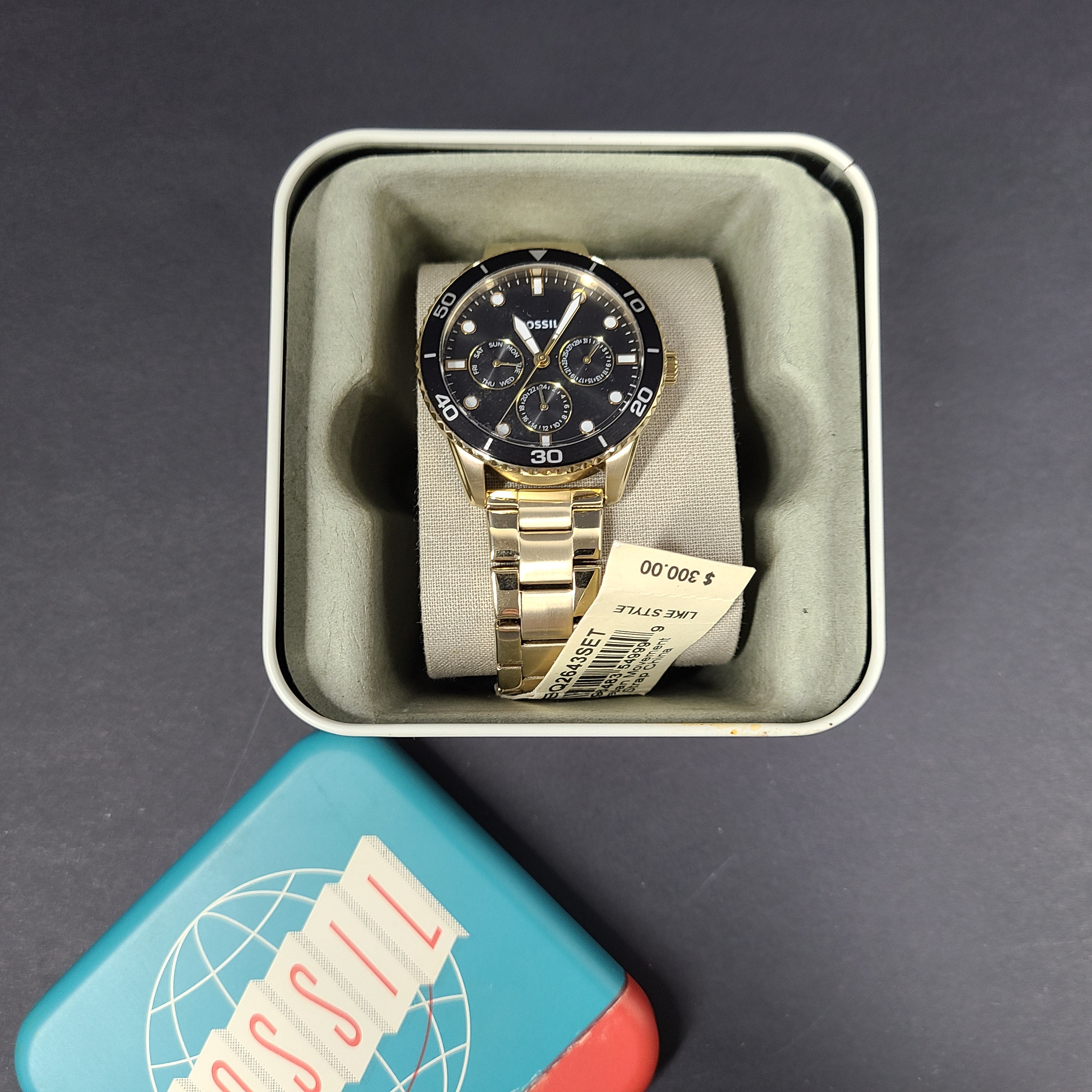 Gold-tone stainless steel his-and-her multifunction watch set with black sunray dials and interchangeable straps.