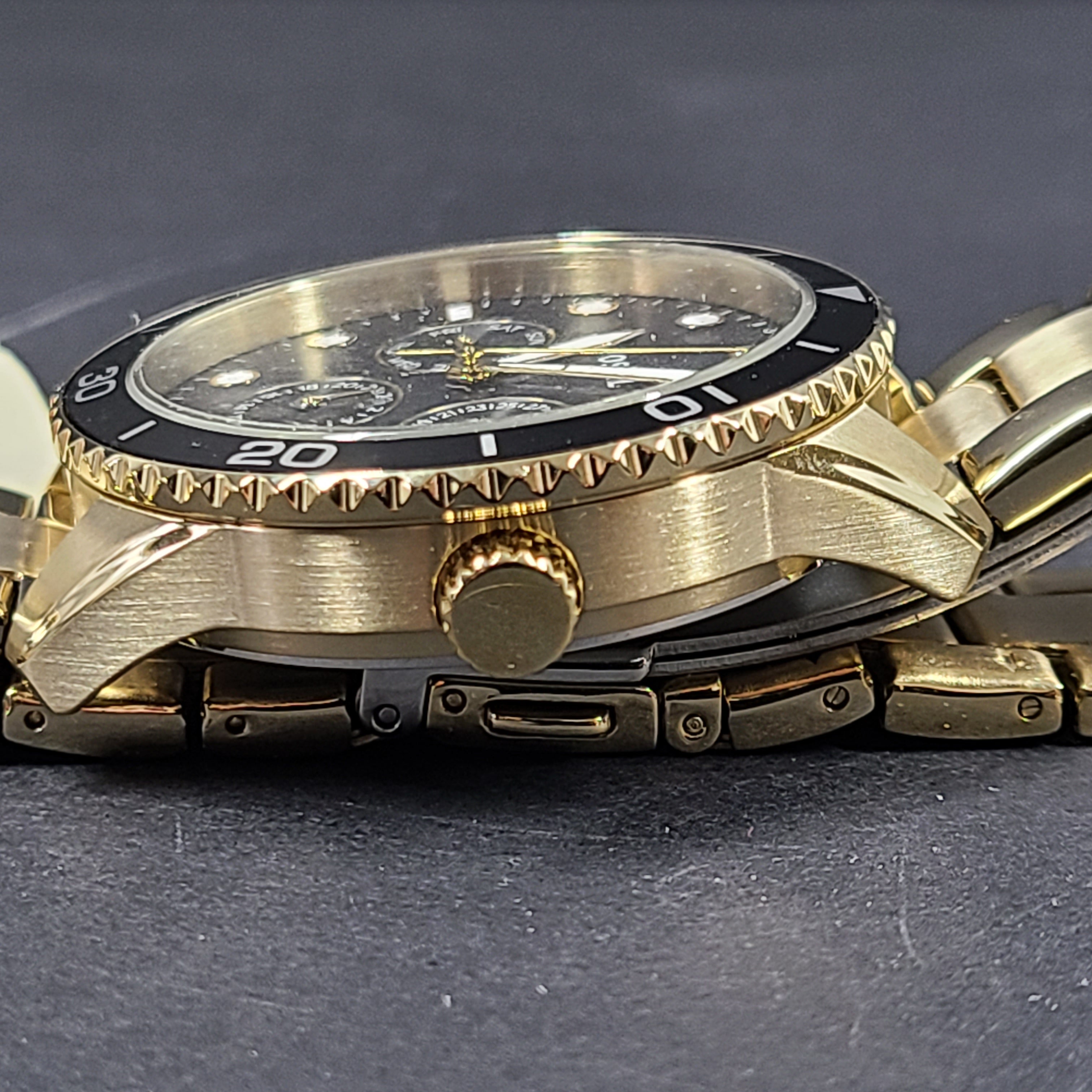 Gold-tone stainless steel his-and-her multifunction watch set with black sunray dials and interchangeable straps.