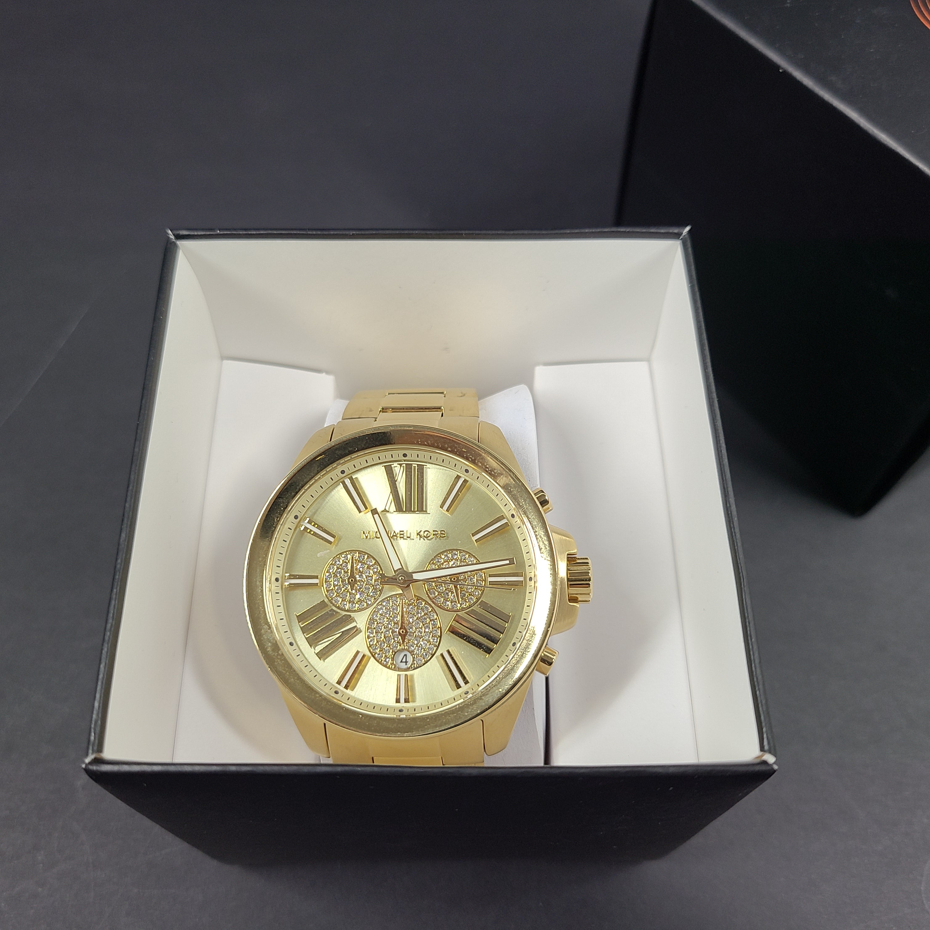 Gold-tone Michael Kors Wren chronograph watch with stainless steel bracelet and pavé sub-dials.