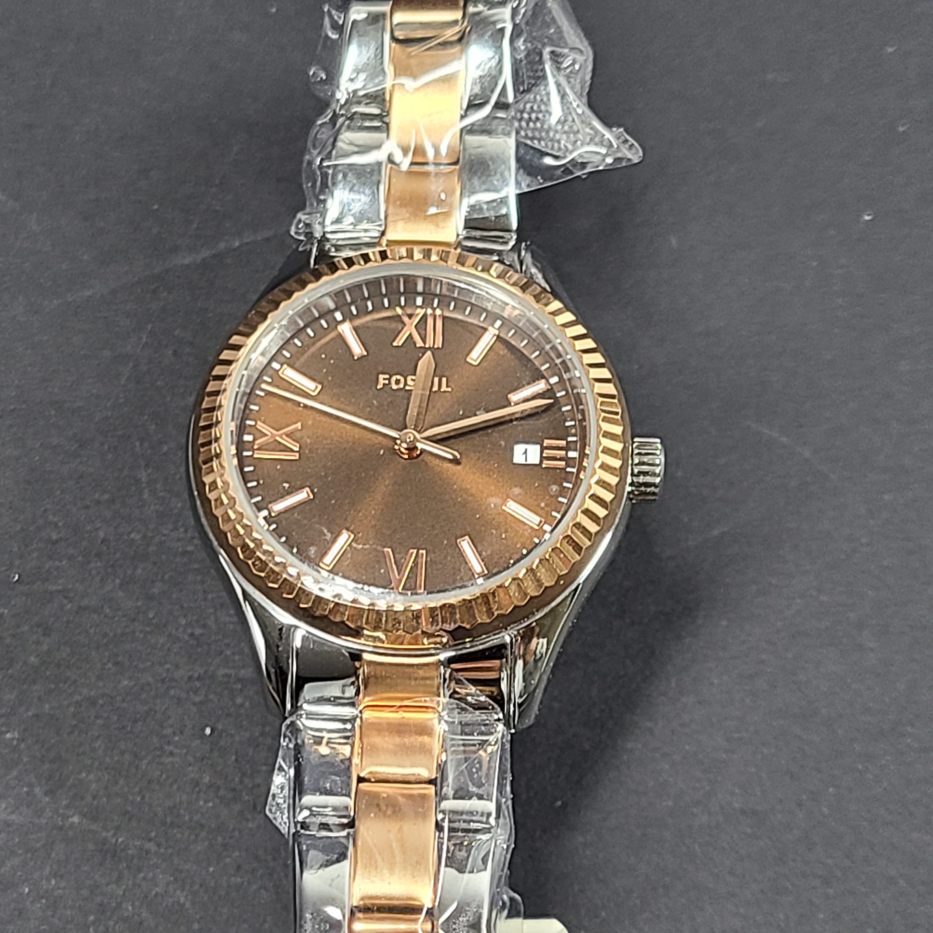 A two-tone Fossil Rye wristwatch with silver and gold stainless-steel bracelet and a date window.