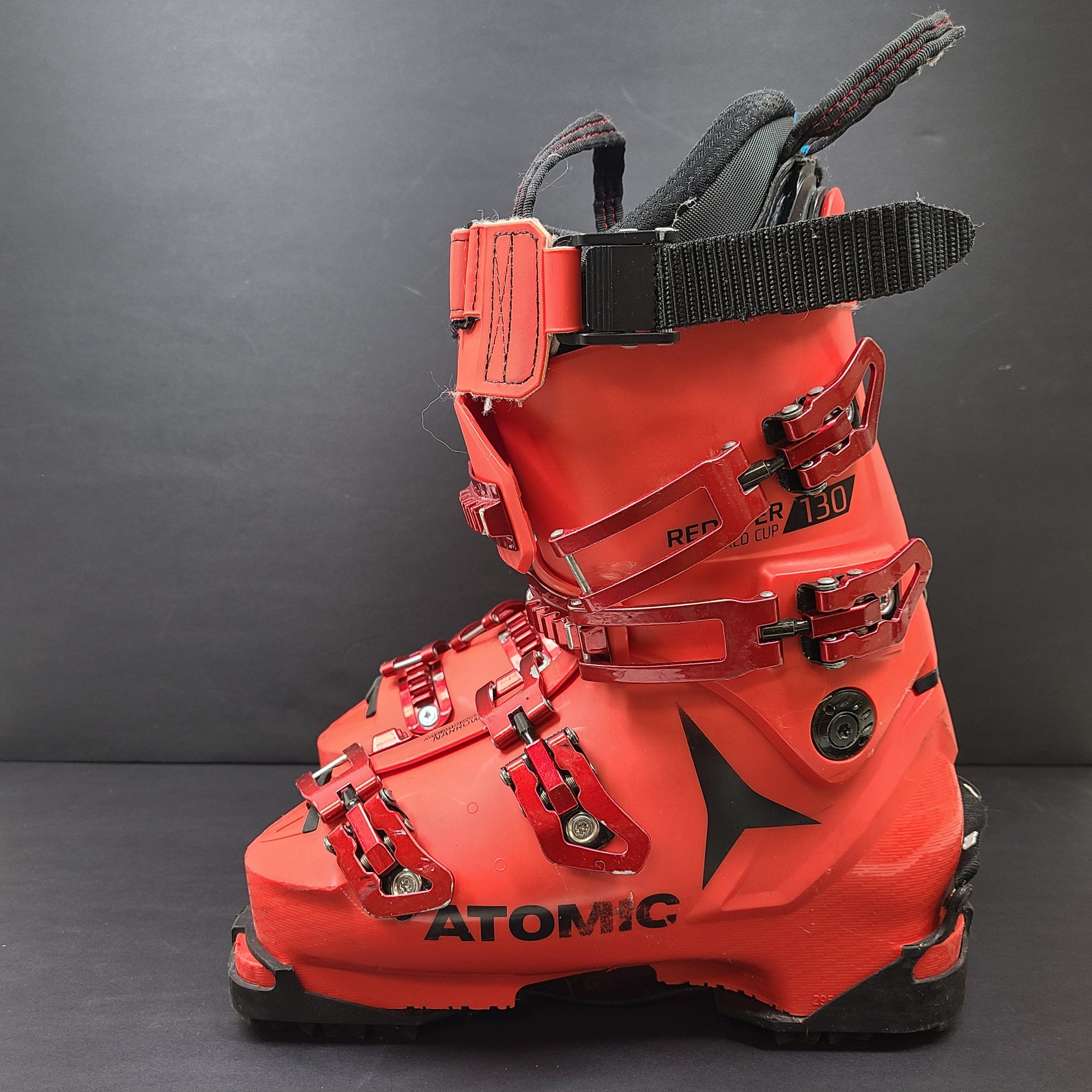 High-performance Atomic Redster World Cup 130 ski boots in red with race-oriented 130 flex and ISO 5355 compatibility.
