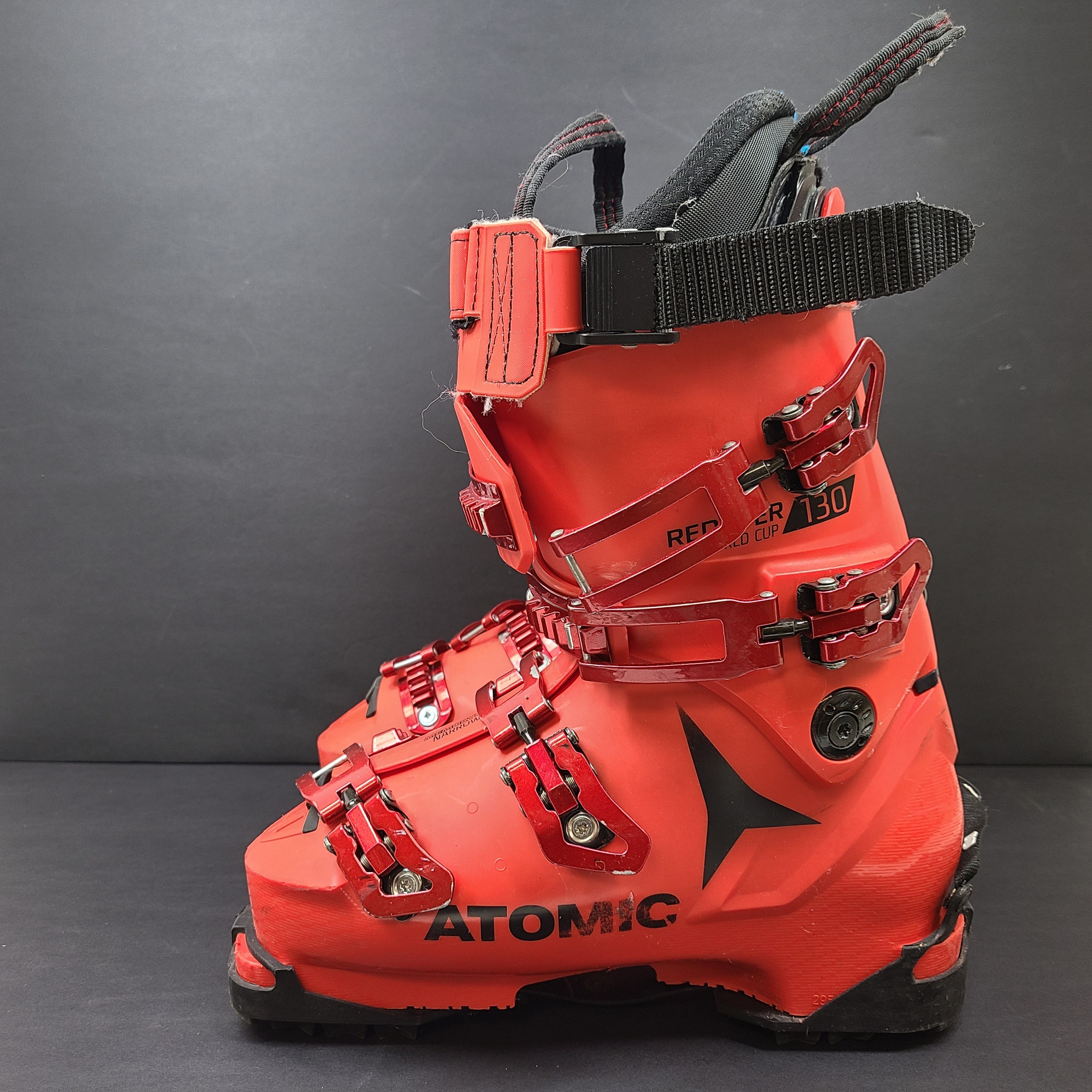 High-performance Atomic Redster World Cup 130 ski boots in red with race-oriented 130 flex and ISO 5355 compatibility.