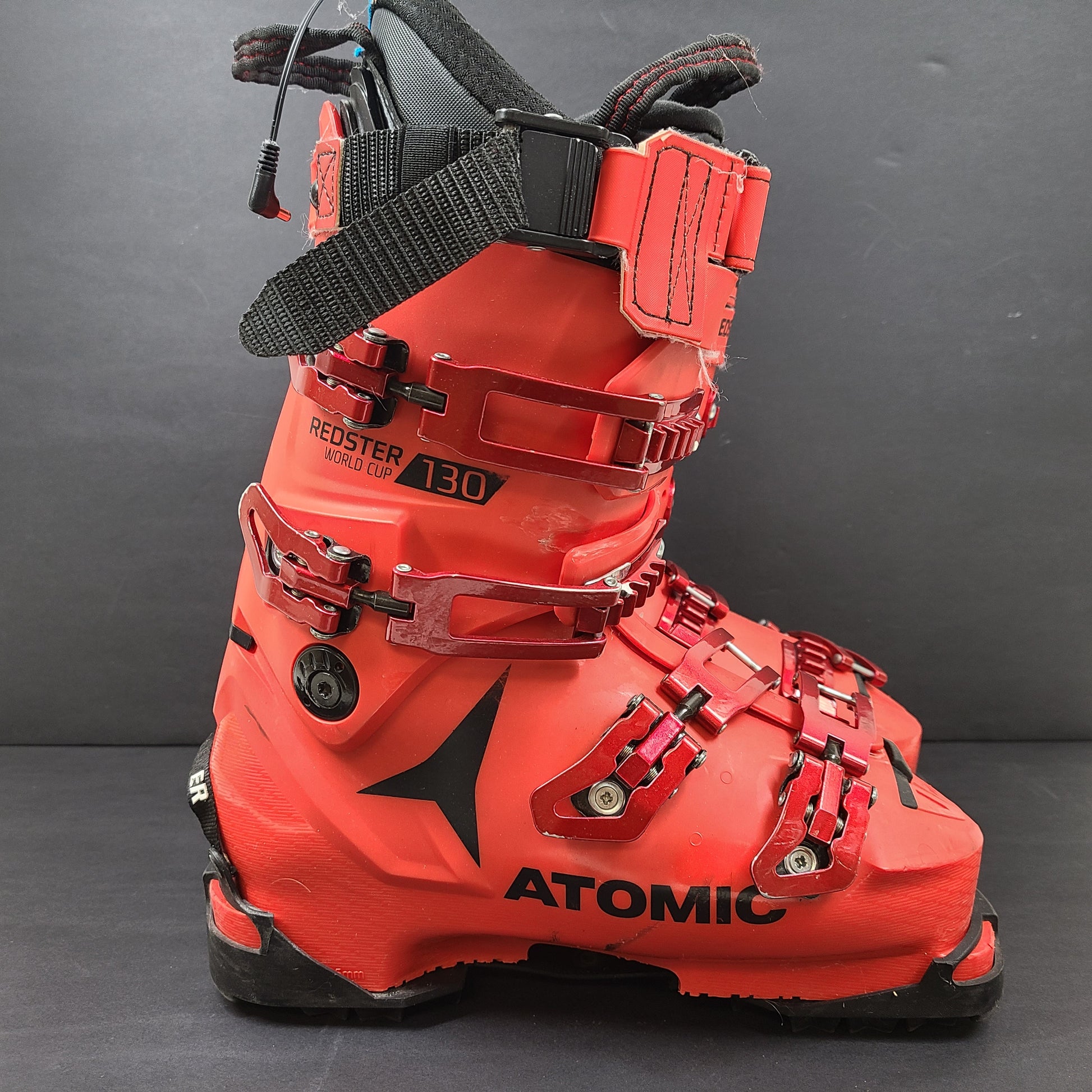High-performance Atomic Redster World Cup 130 ski boots in red with race-oriented 130 flex and ISO 5355 compatibility.