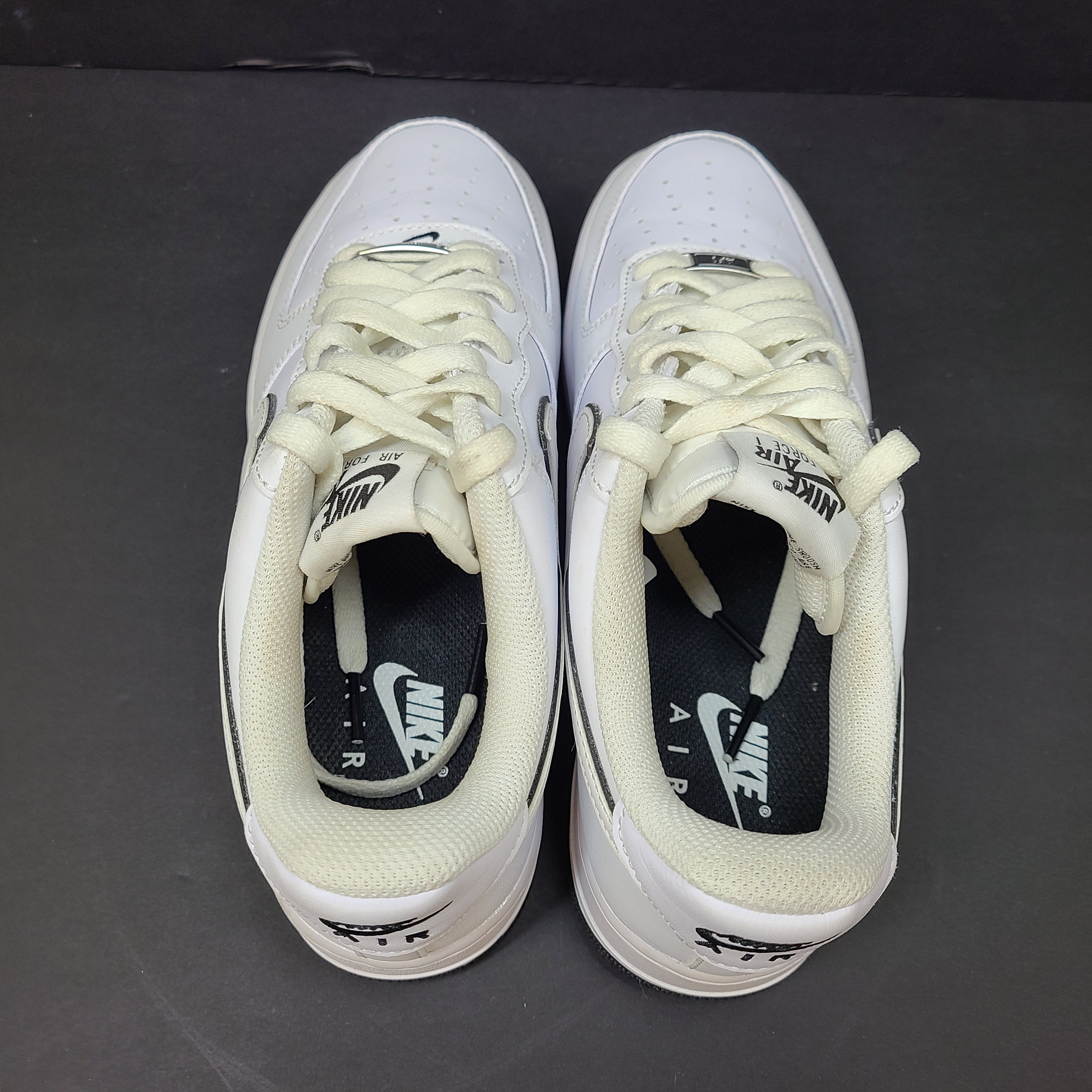 Classic Nike Air Force 1 Low in white with black accents, size US 7.5, model DV0818-103.
