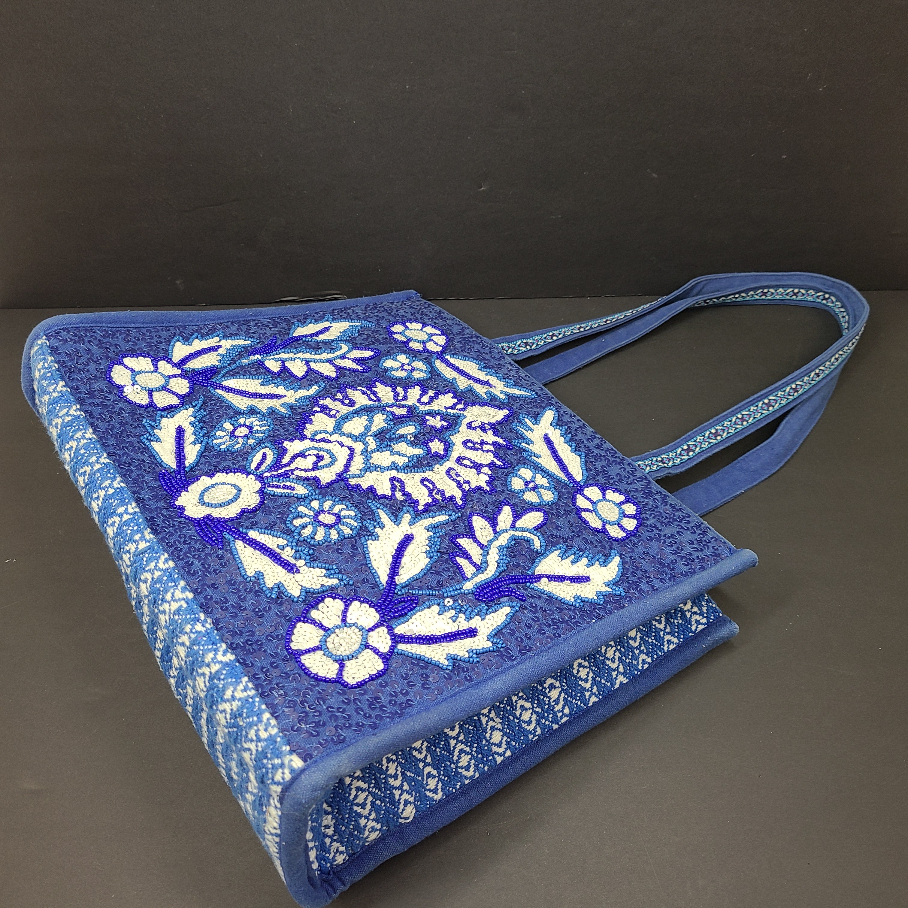 America & Beyond embroidered blue and white tote with floral and leopard interior and interior label reading AMERICA & BEYOND.