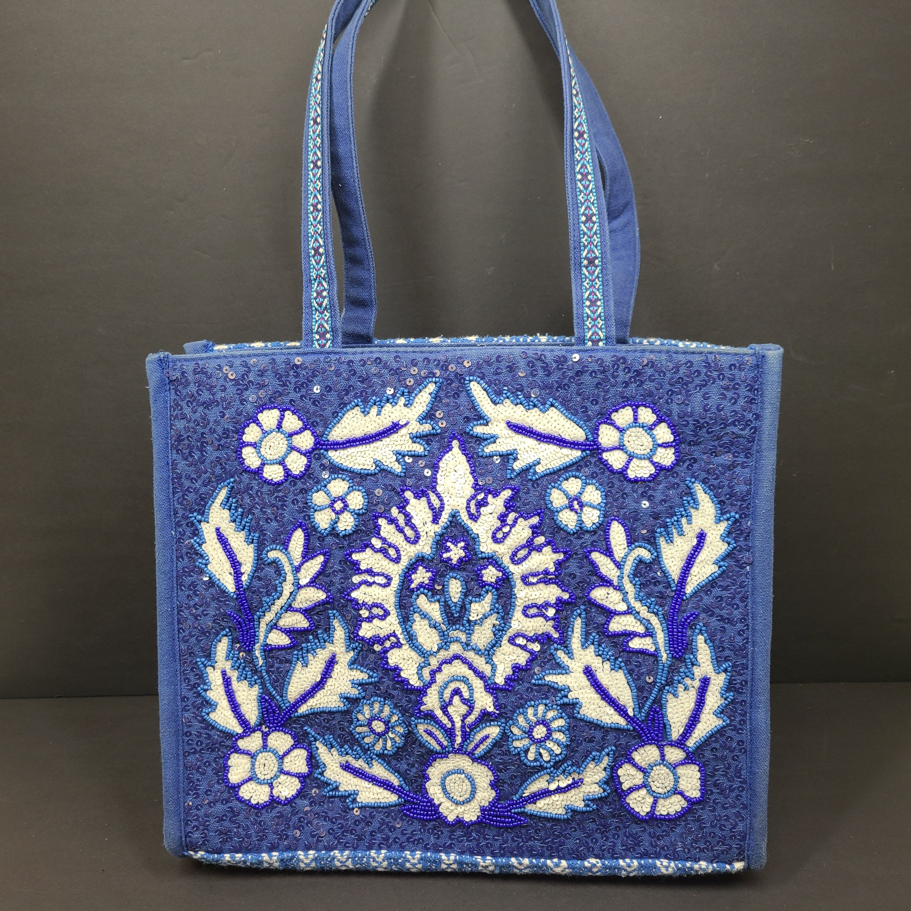 America & Beyond embroidered blue and white tote with floral and leopard interior and interior label reading AMERICA & BEYOND.