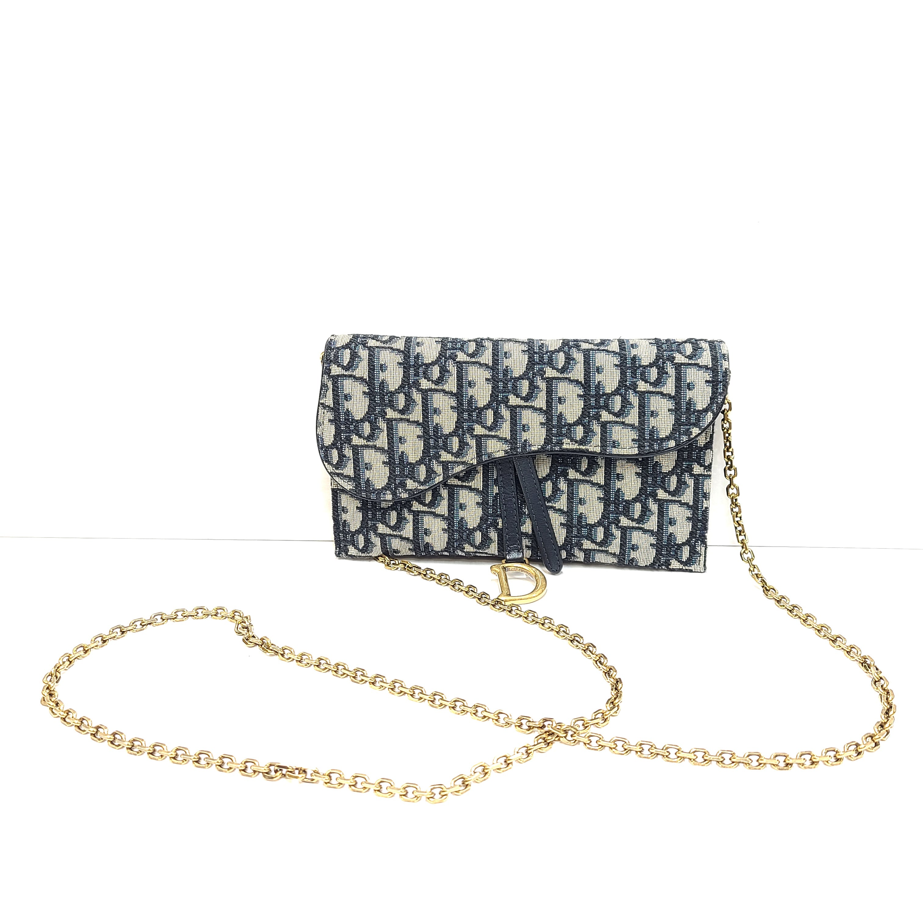 Christian Dior blue leather handbag with a gold chain strap and matching pouch.