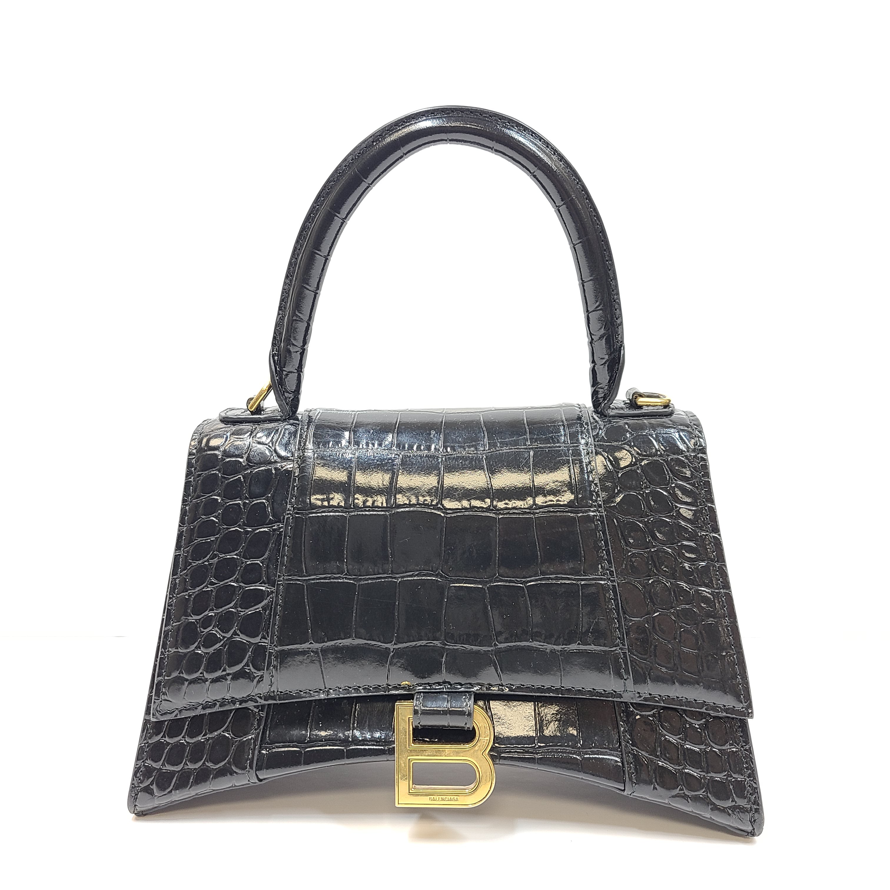 Balenciaga crocodile-embossed black leather handbag with branded buckle and detachable strap.
