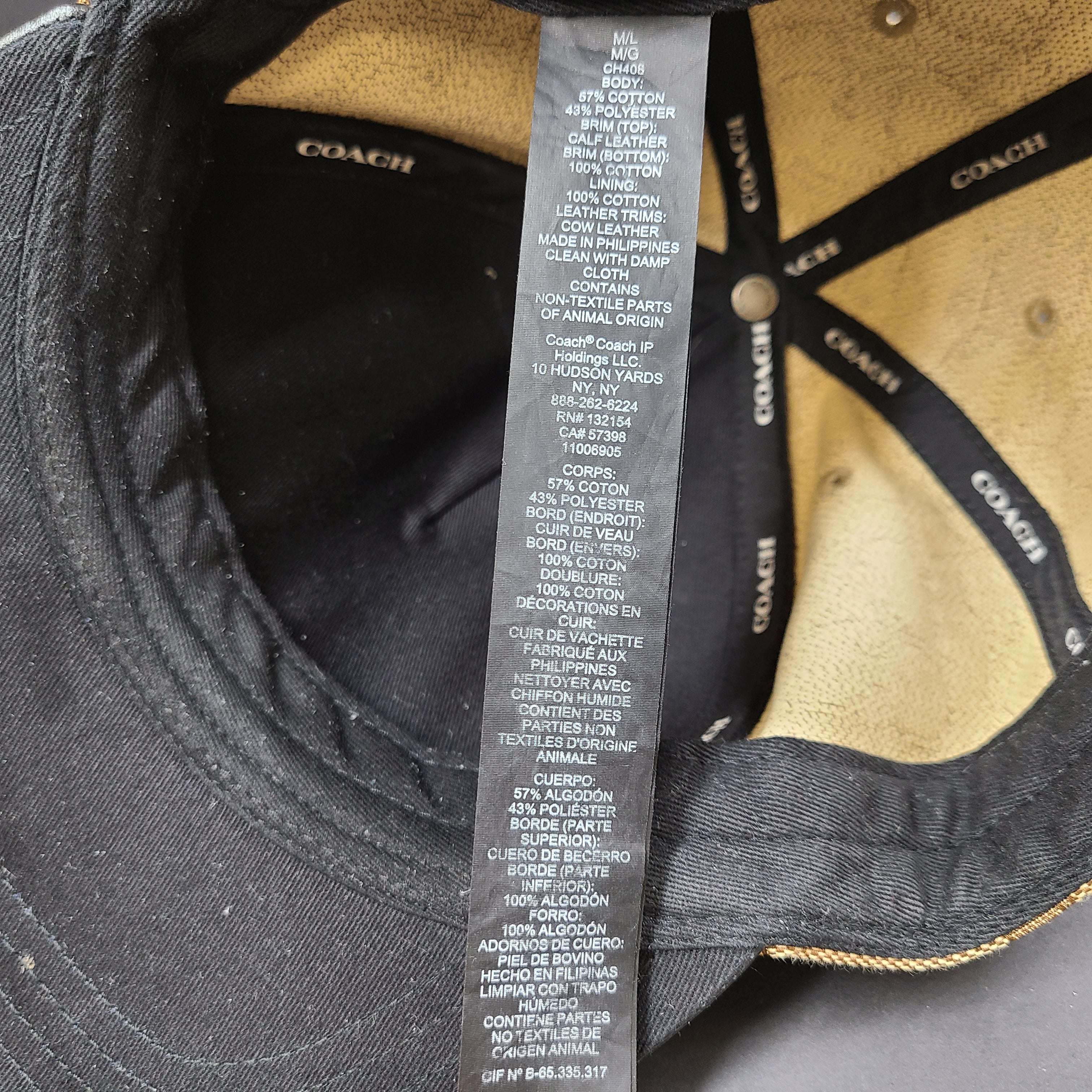 Tan and black Coach baseball cap in M/L size with canvas body and leather brim.