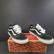 Low-top Vans Old Skool skate shoe in black with a white side stripe and vulcanized sole.